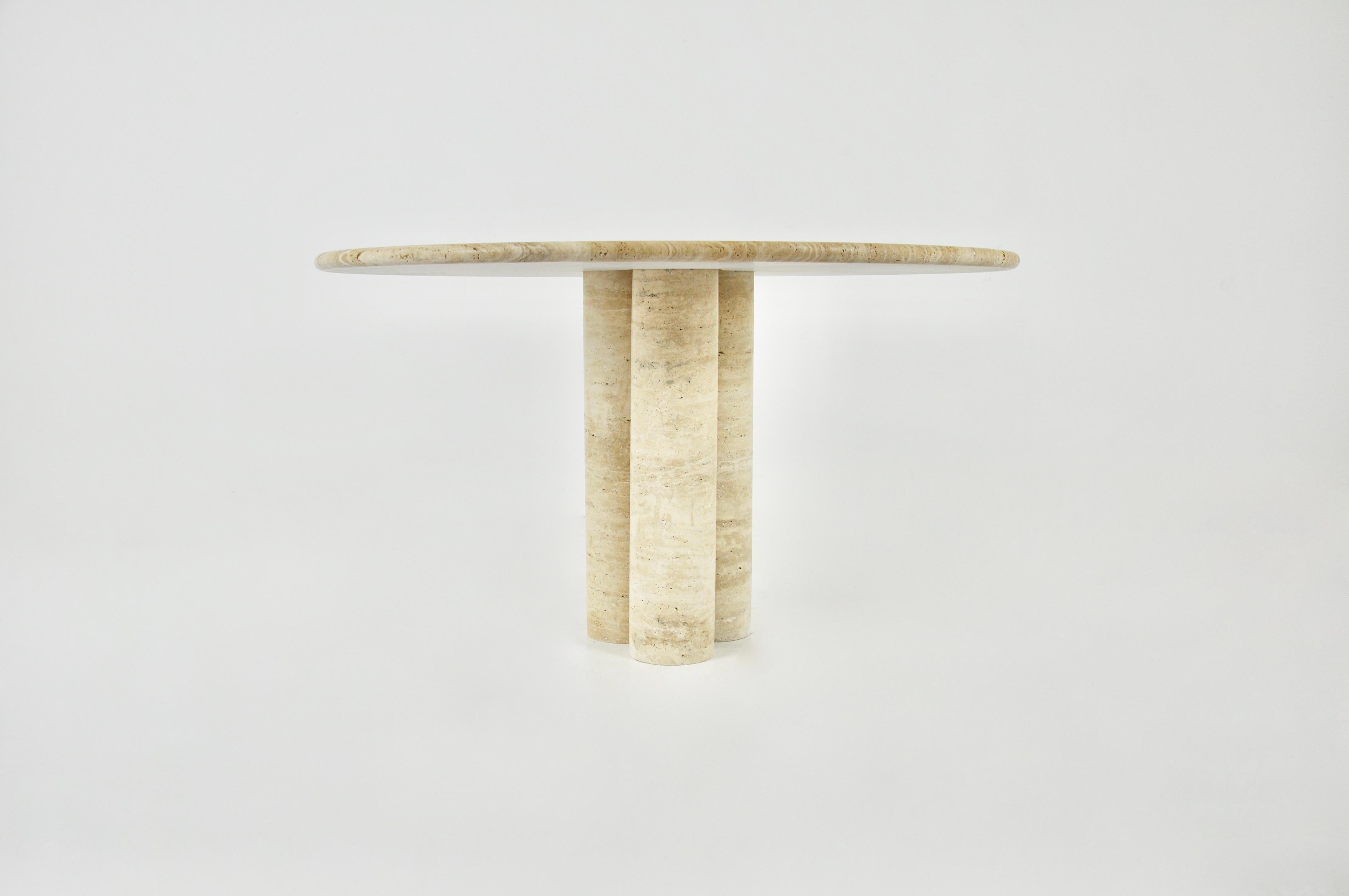 Contemporary circular travertine dining table with 3 legs in the centre of the table.
 