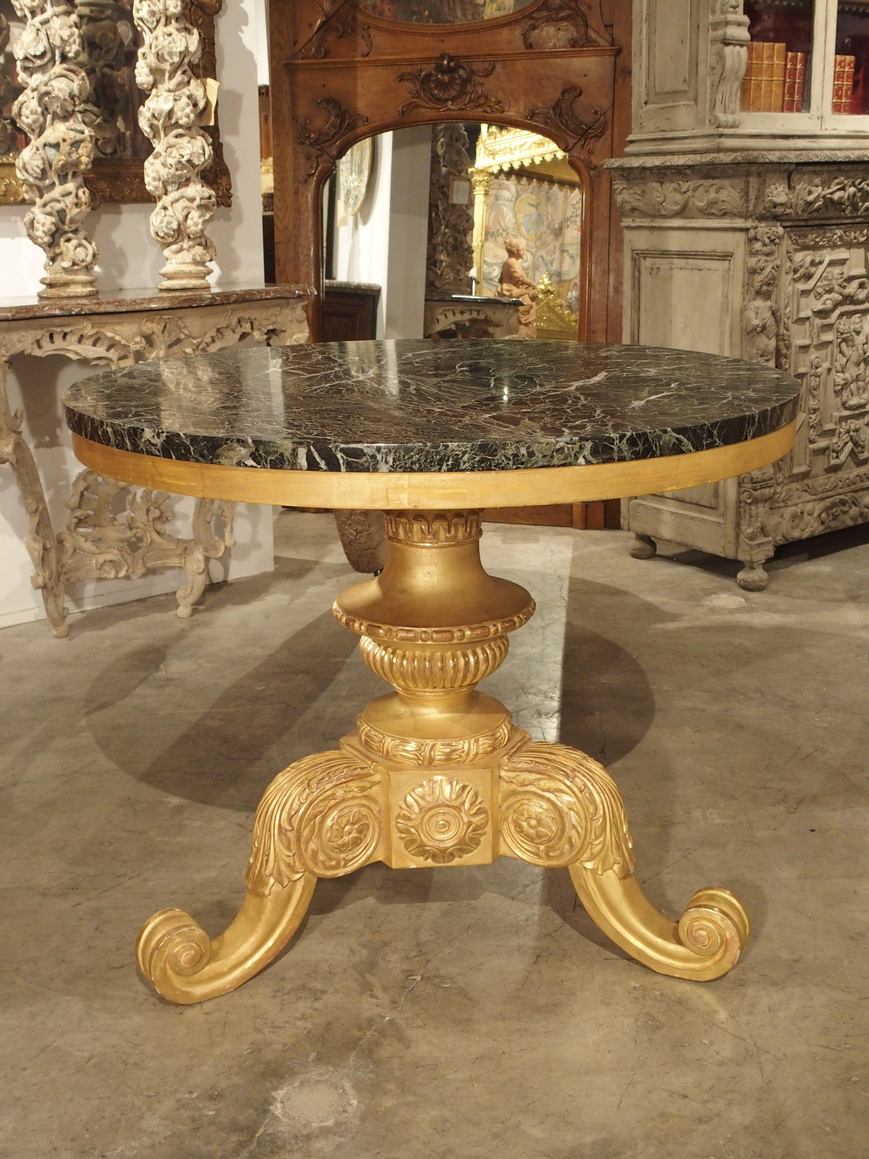 This circular tripartite giltwood and marble center table was produced in France in the early 1900’s. The table is in the style of Napoleon III, which is sometimes referred to as The Second Empire style. Napoleon III is unique in that there were no