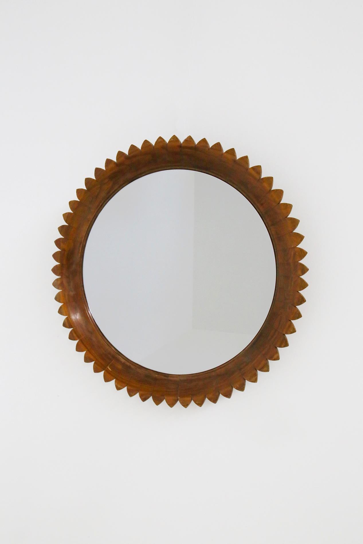 Elegant and important circular mirror made by the Italian manufacture Fratelli Marelli in 1950s. Turin.
The mirror is made of walnut wood with sun-shaped segments. Wonderful patina. For its beauty it looks like a sculptural work of art.
The mirror