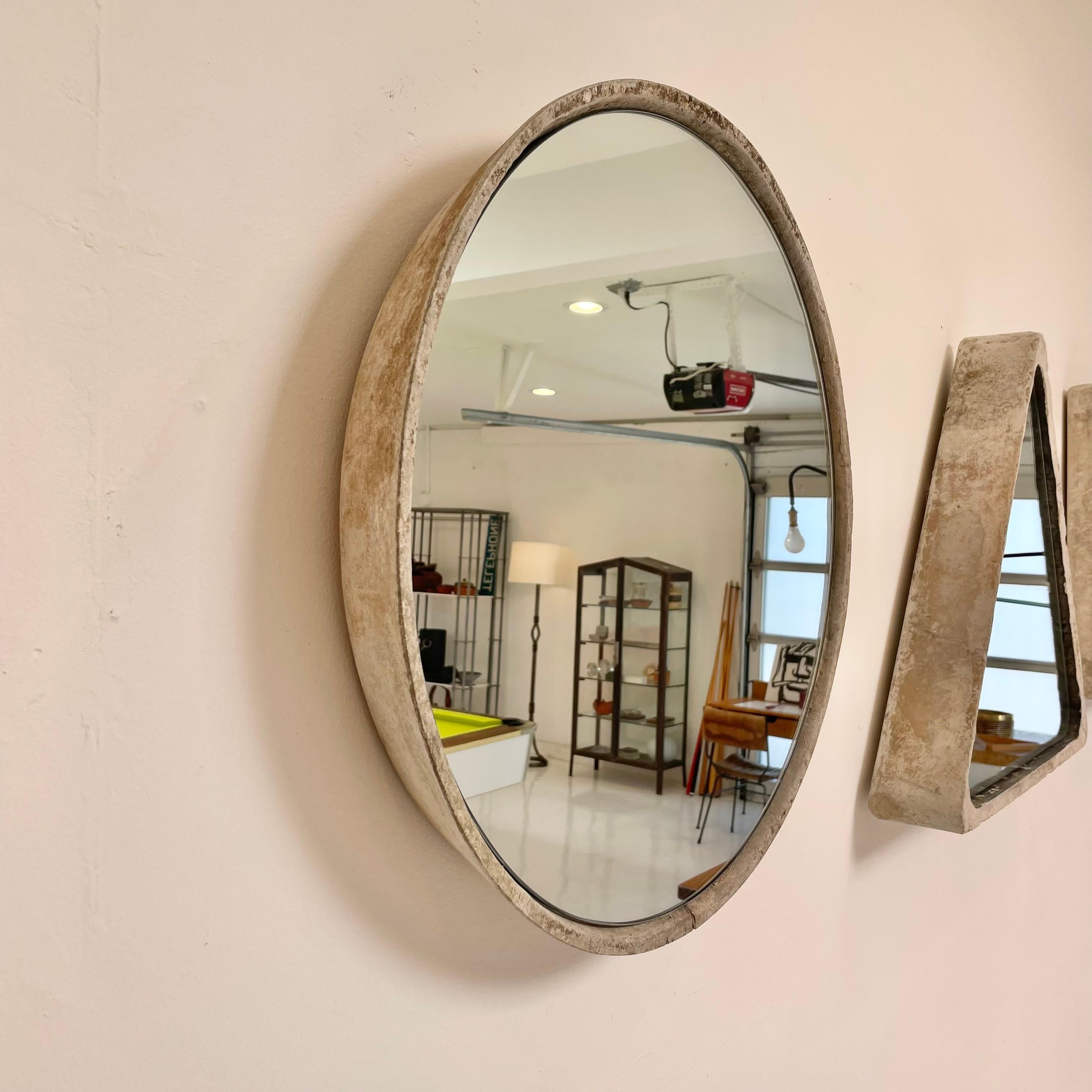 Very cool and unique circular Willy Guhl concrete mirror. Concrete vessel originally produced at the Eternit factory in Switzerland in the 1960’s and mirror was professionally hand cut and added recently. Beautiful patina as expected with age