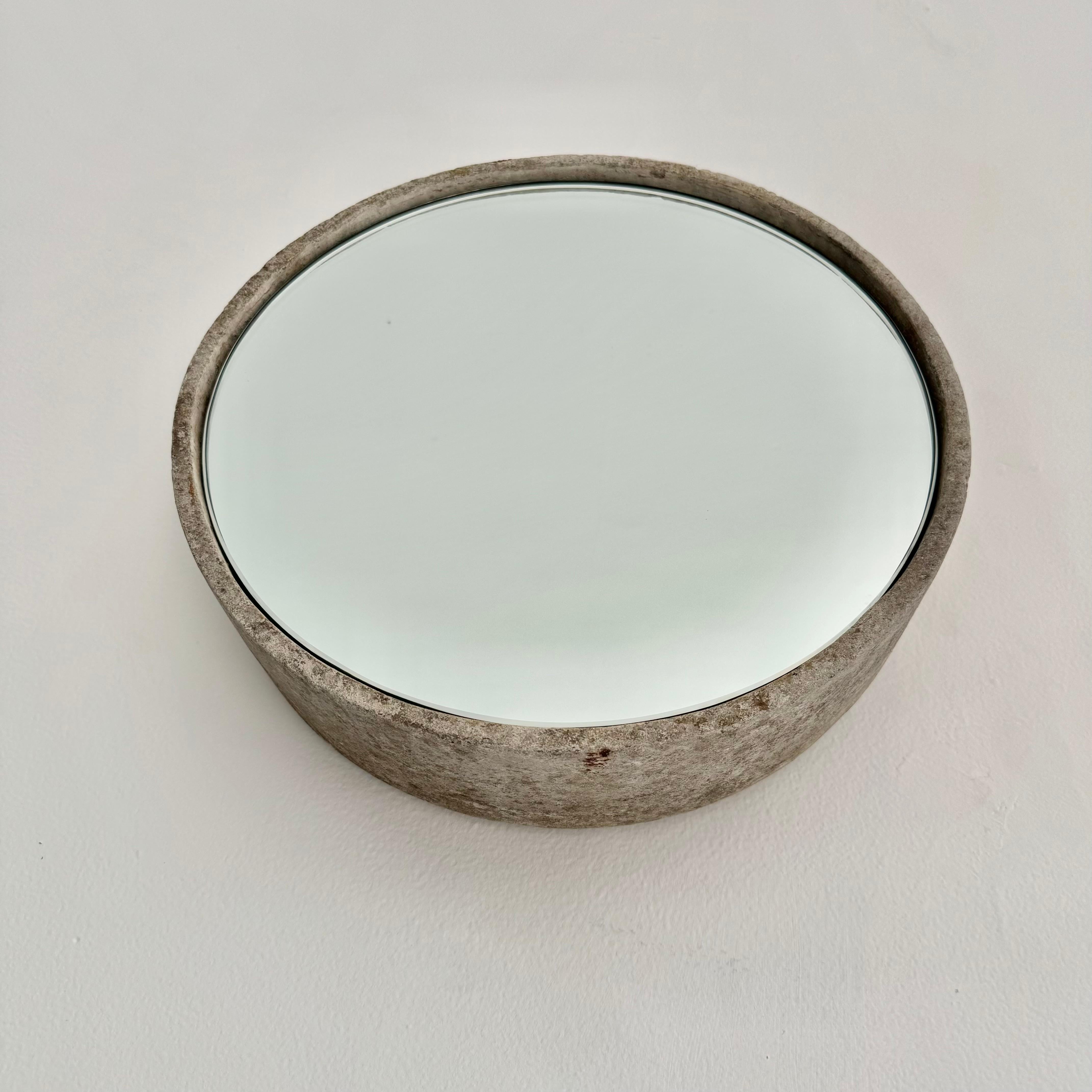 Very cool and unique circular Willy Guhl concrete mirror. Concrete vessel originally produced at the Eternit factory in Switzerland in the 1960’s. Custom mirror/ glass was professionally hand cut and added recently. Beautiful patina as expected with