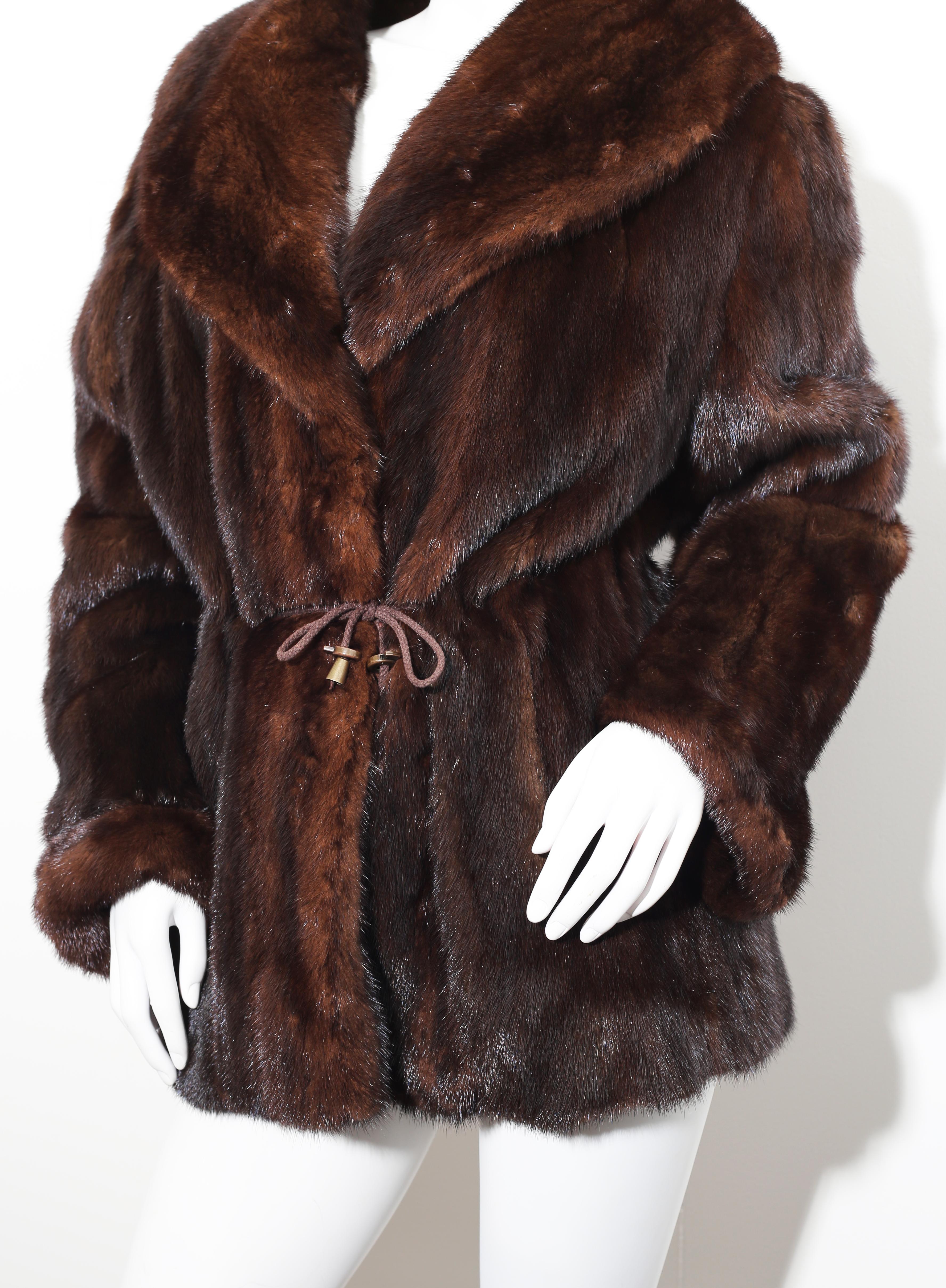 Cirilo Fernandez   mink adjustable coat three quarters  with a gorgeous adjustable collar. The collar can be formed at the front to be worn completely up, down, or slightly up! 
This fabulous coat has a gentle aline cut and hits mid-thigh.
 It has