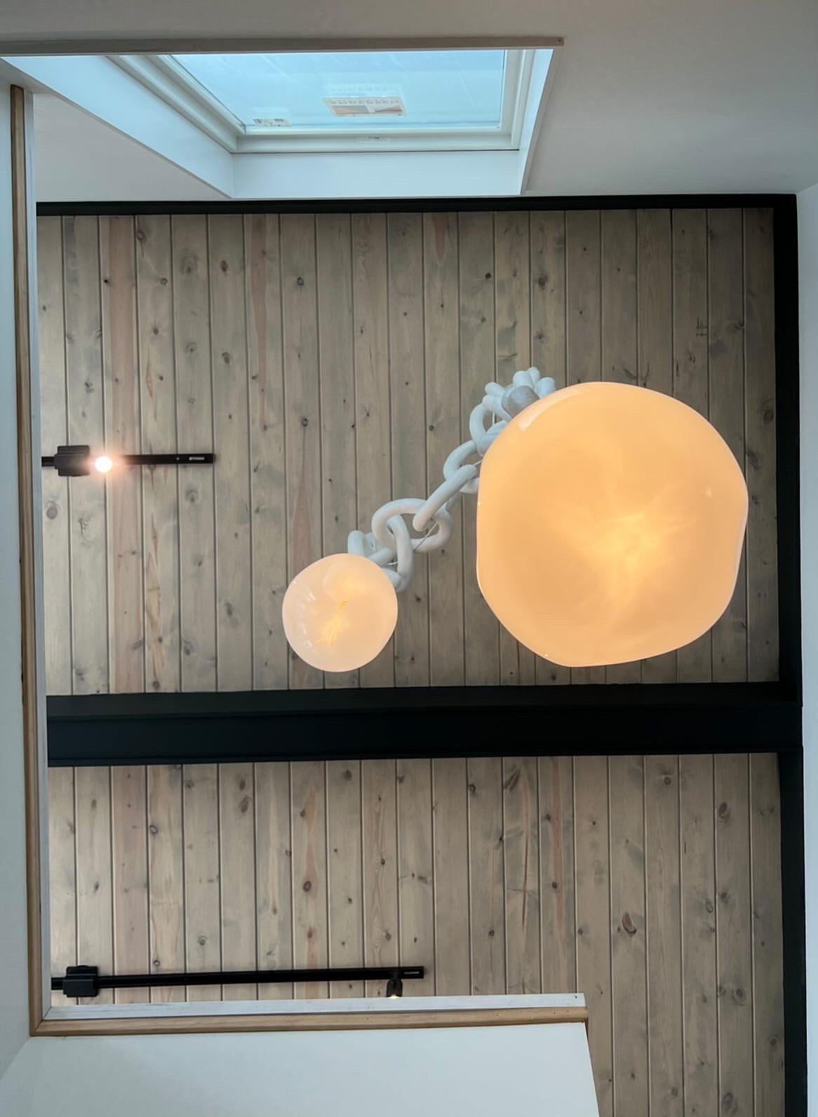 Sculptural, bold, and unmistakably modern, the 2 Drop Double Swagged Chandelier transforms any space into a statement. Handcrafted in our Georgia, USA studio, this artful fixture begins with a solid wood and metal base, sculpted by hand using a