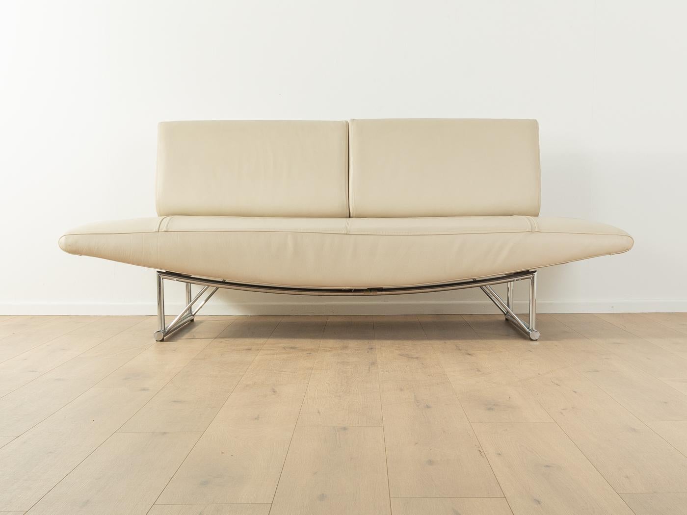 CIRRUS Sofa by Peter Maly for COR from the 1980s. High quality solid stainless steel frame with the original leather cover in cream white. The sofa can be transformed from an open sofa into an elegant chaise longue or a daybed with a bigger lying