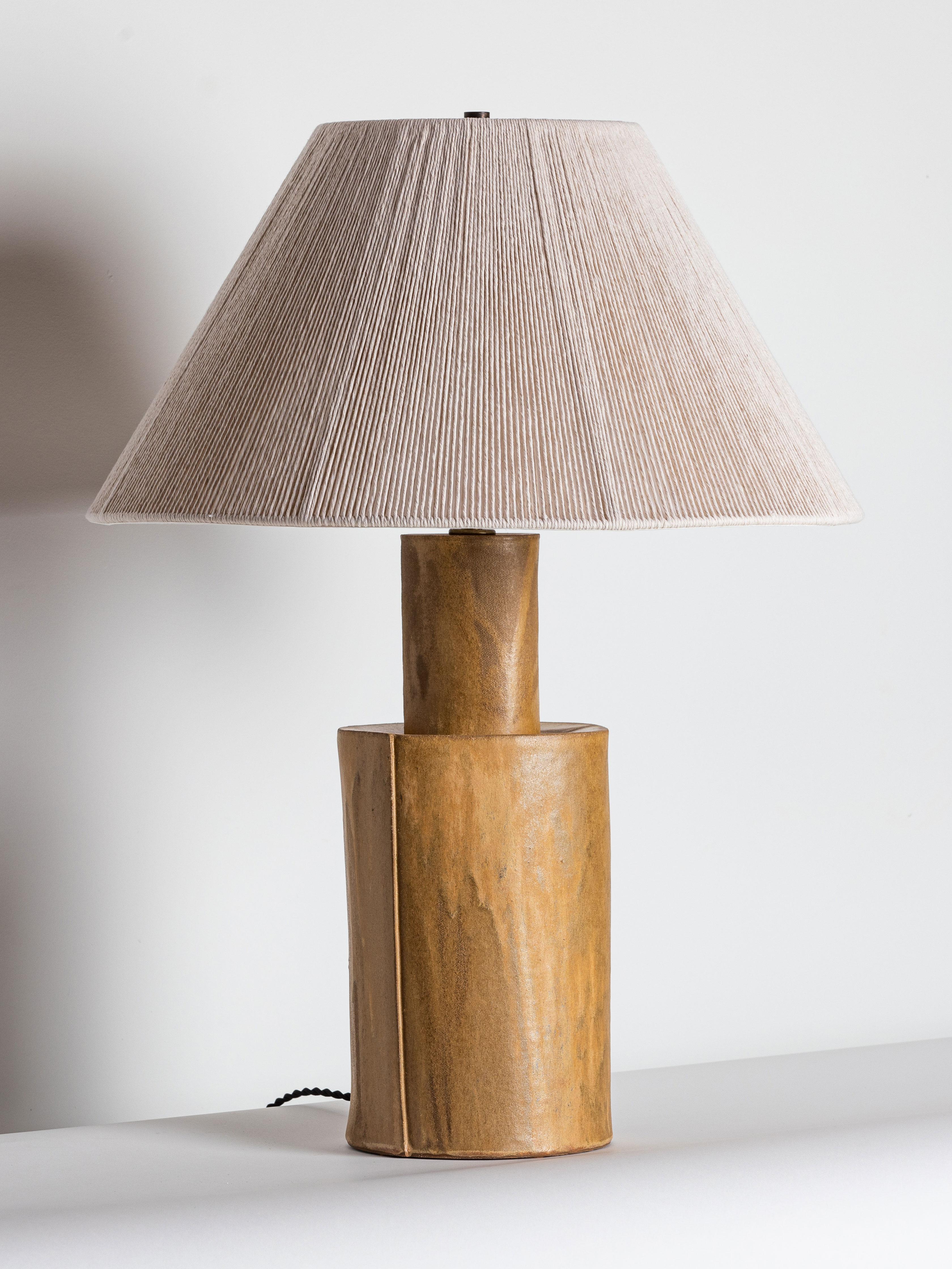 Our stoneware Cistern Lamp is handcrafted using slab-construction techniques.

FINISH

- Poured glaze, pictured in hide
- Antique brass fittings
- Twisted black-cloth cord
- Full-range dimmer socket
- String shade

BULB

60-watt frosted