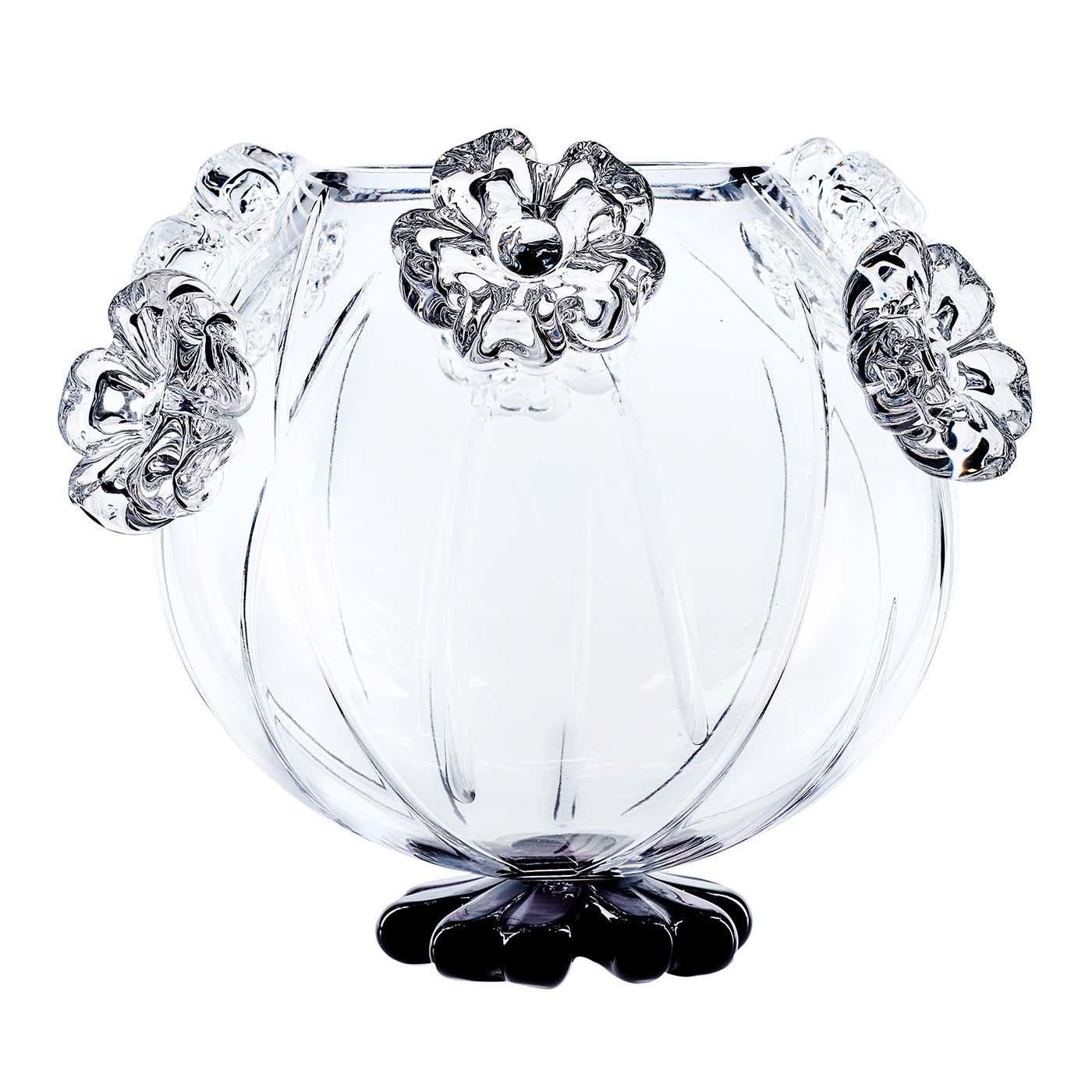 Part of the Cistus collection, this vase was completely handcrafted and is characterized by a round body of transparent crystal adorned with seven flowers positioned around the top at alternating heights, with a black base shaped like a flower.