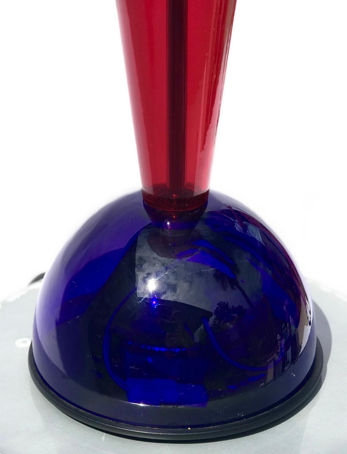 Rare and striking table lamp model Citera designed by Andrea Anastasio for Artemide in multicolored glass with a single halogen socket and four curvilinear, decorative glass stems extending upwards. The body of the lamp comprises three sections that
