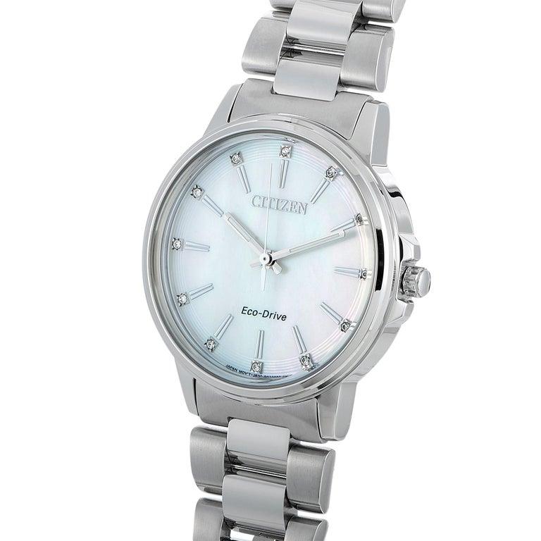 This is the Citizen Chandler Eco-Drive watch, reference number FE7030-57D. It boasts a 37 mm stainless steel case presented on a matching stainless steel bracelet, secured on the wrist with a deployment clasp. The white mother of pearl dial is set