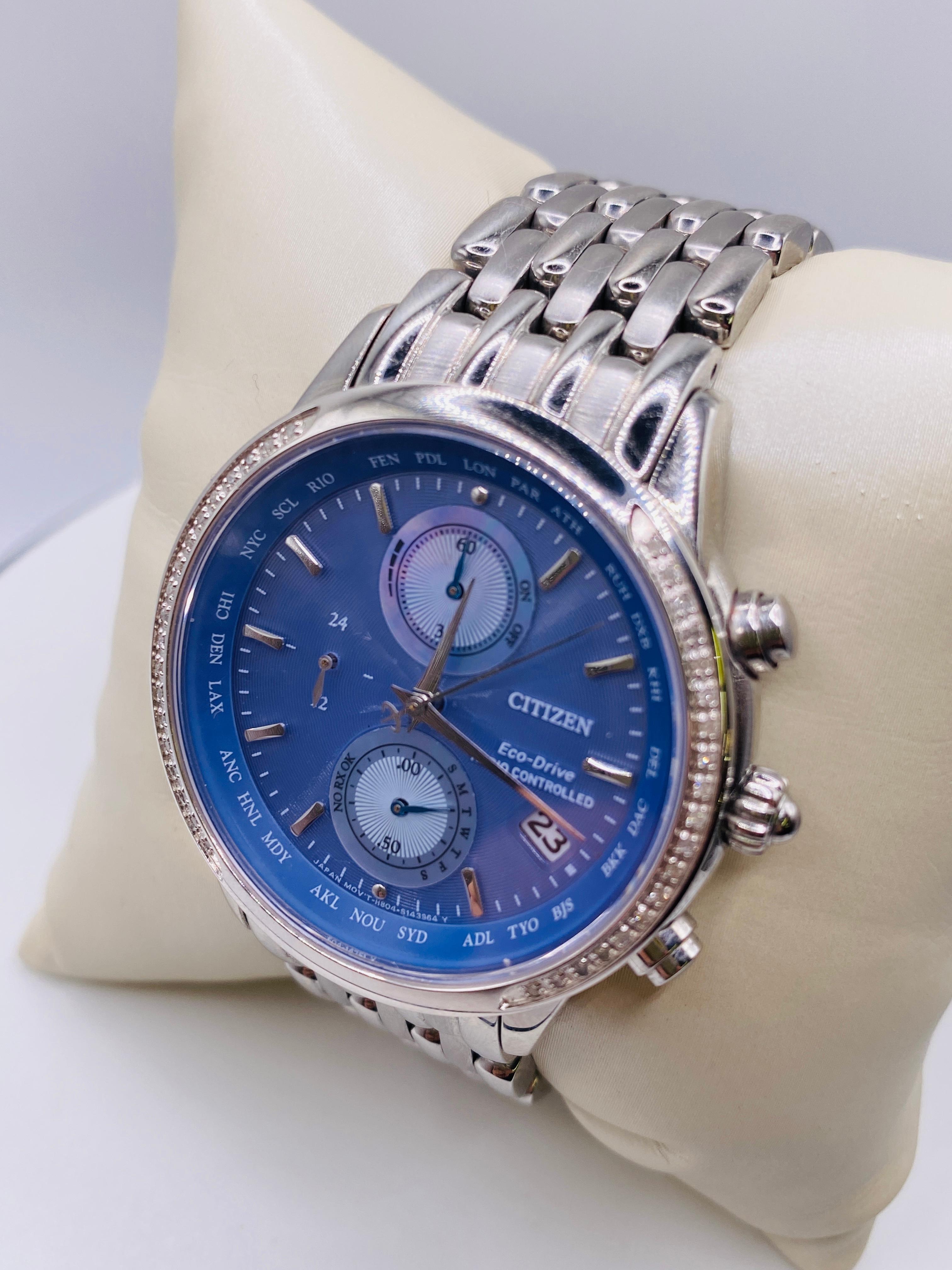 Citizen Eco Drive Radio Controlled Purple Dial Stainless Steel Watch. World chronograph A-T, 40 mm case, periwinkle blue dial, 26 time zones, solar powered, sapphire crystal, movement made in Japan. Model H804-S103614, Serial 591020538.