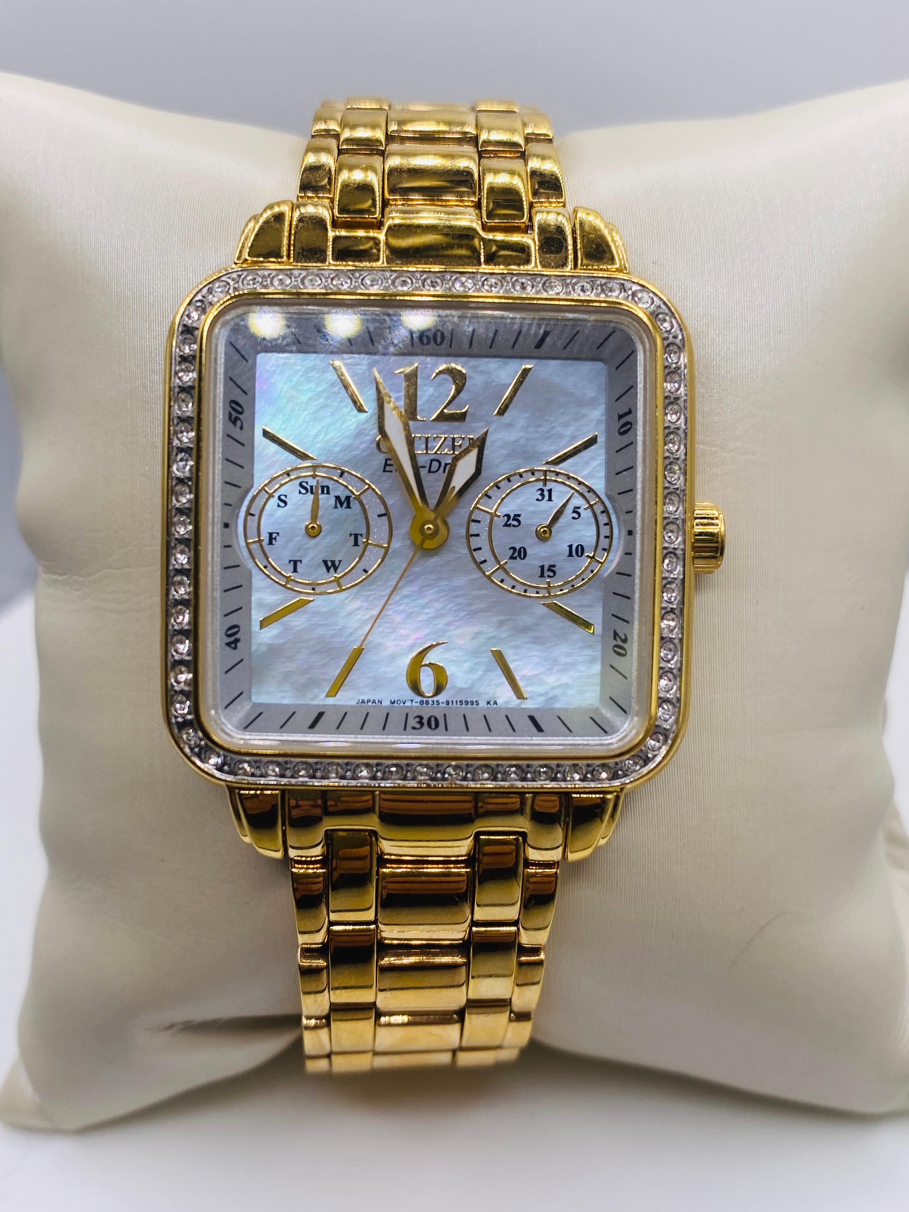 Citizen Eco Drive Watch with Swarovski Crystals and Mother of Pearl Dial. Yellow gold plated stainless steel 32mm case and bezel enhanced with Swarovski crystals. Water Resistant. Fold over clasp with push button.  Movement/Case No. 8635-S079586.
