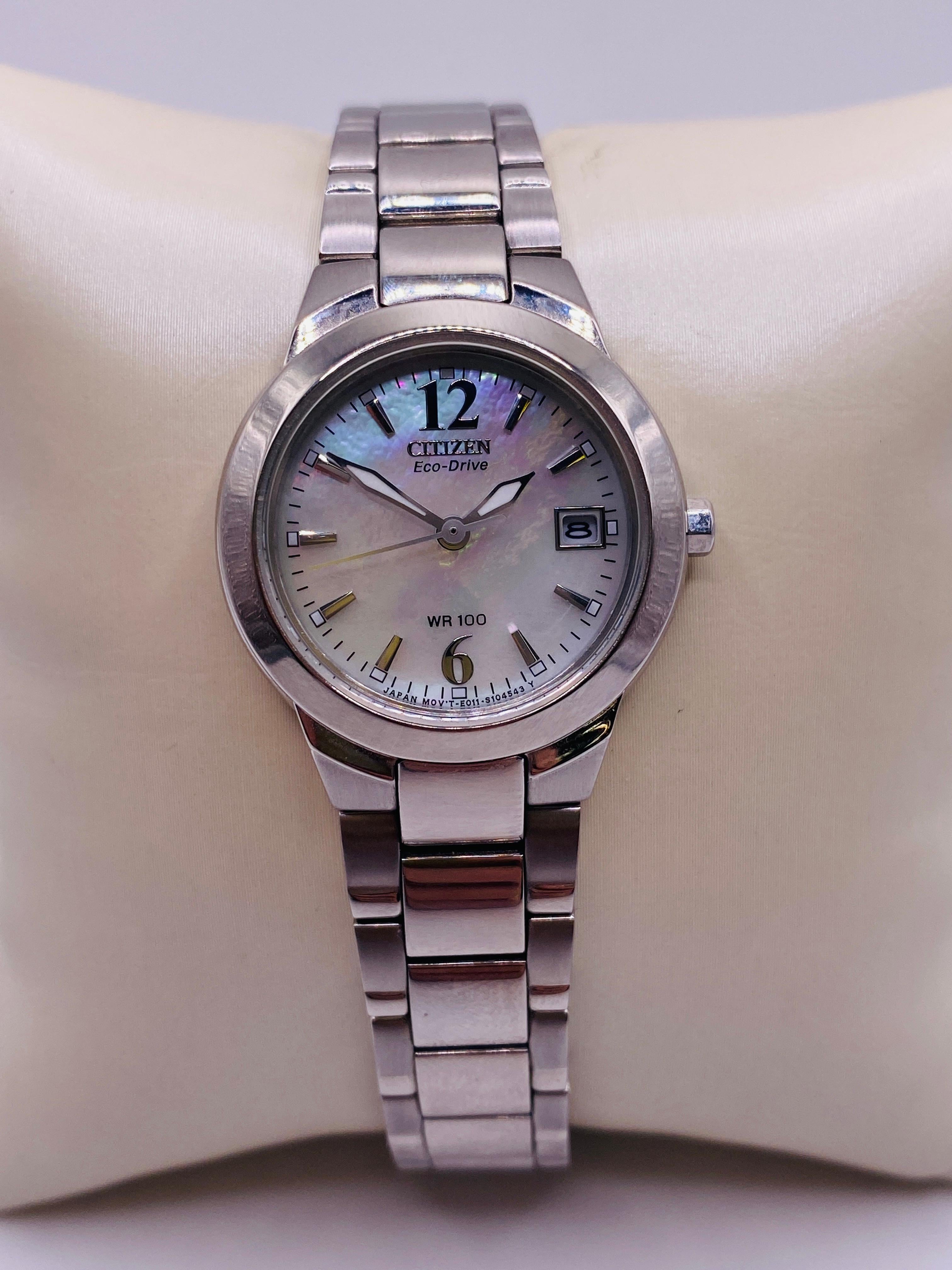 Citizen Eco-Drive WR100 Chandelier Ladies Watch with Stainless Steel Band, 26mm case, Mother of Pearl dial and fold over clasp with push button. Japanese movement. Model E011-S070074. Serial 461030723