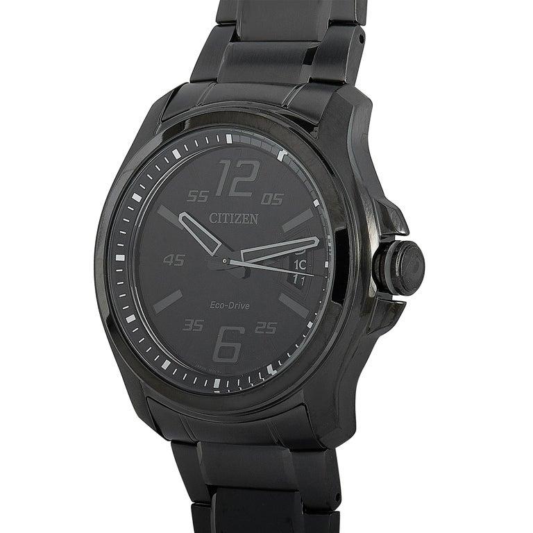This is the Citizen HTM Eco-Drive watch, reference number AW1354-82E. The case and the bracelet are made of stainless steel and boast black polymatte finish. The case measures 43 mm in diameter and is water-resistant to 100 meters. The black dial