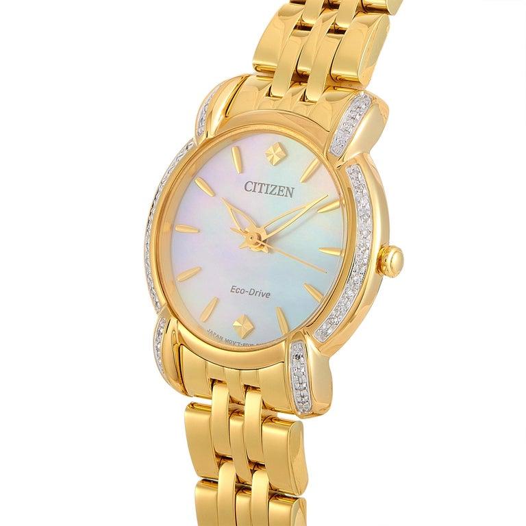 This is the Citizen Jolie Eco-Drive watch, reference number EM0692-54D. It is presented with a diamond-set, gold-tone stainless steel case that measures 30 mm in diameter. Powered by the Eco-Drive E031 movement, this model indicates hours, minutes