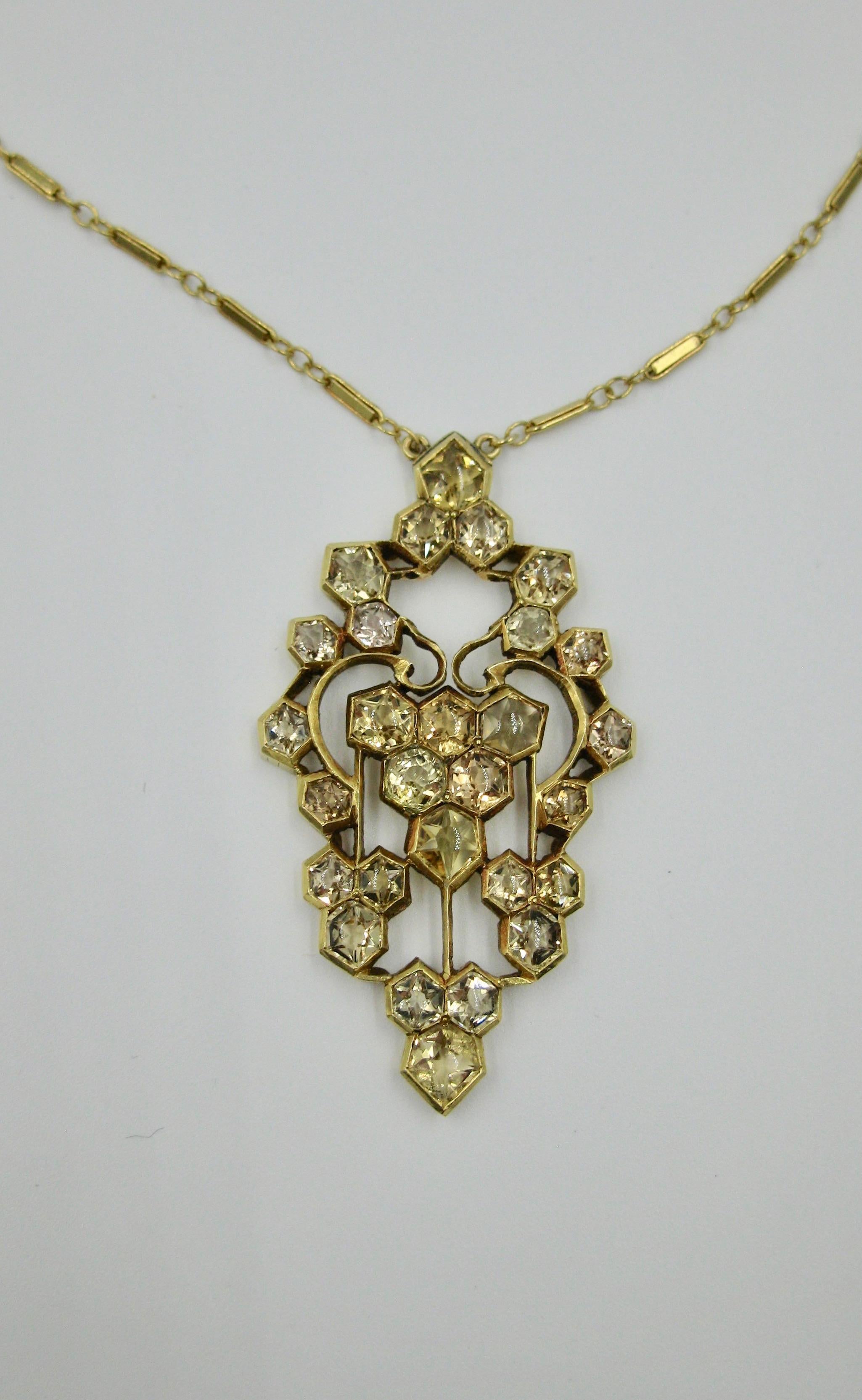 This is a fantastic and rare Early 20th Century Citrine Pendant Necklace in 14 Karat Yellow Gold.  The jewel is just stunning.  The rare pendant is set with 28 hexagonally cut Citrines of various sizes.  The gorgeous citrine gems shimmer in the 14