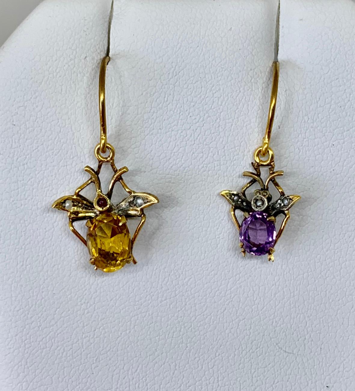 This is a wonderful pair of rare antique Fly Insect Earrings in Gold with gorgeous Citrine and Amethyst gems with 
Pearl accents.  The Victorian - Edwardian jewels are beautifully made with an oval faceted Amethyst and oval faceted Citrine making up