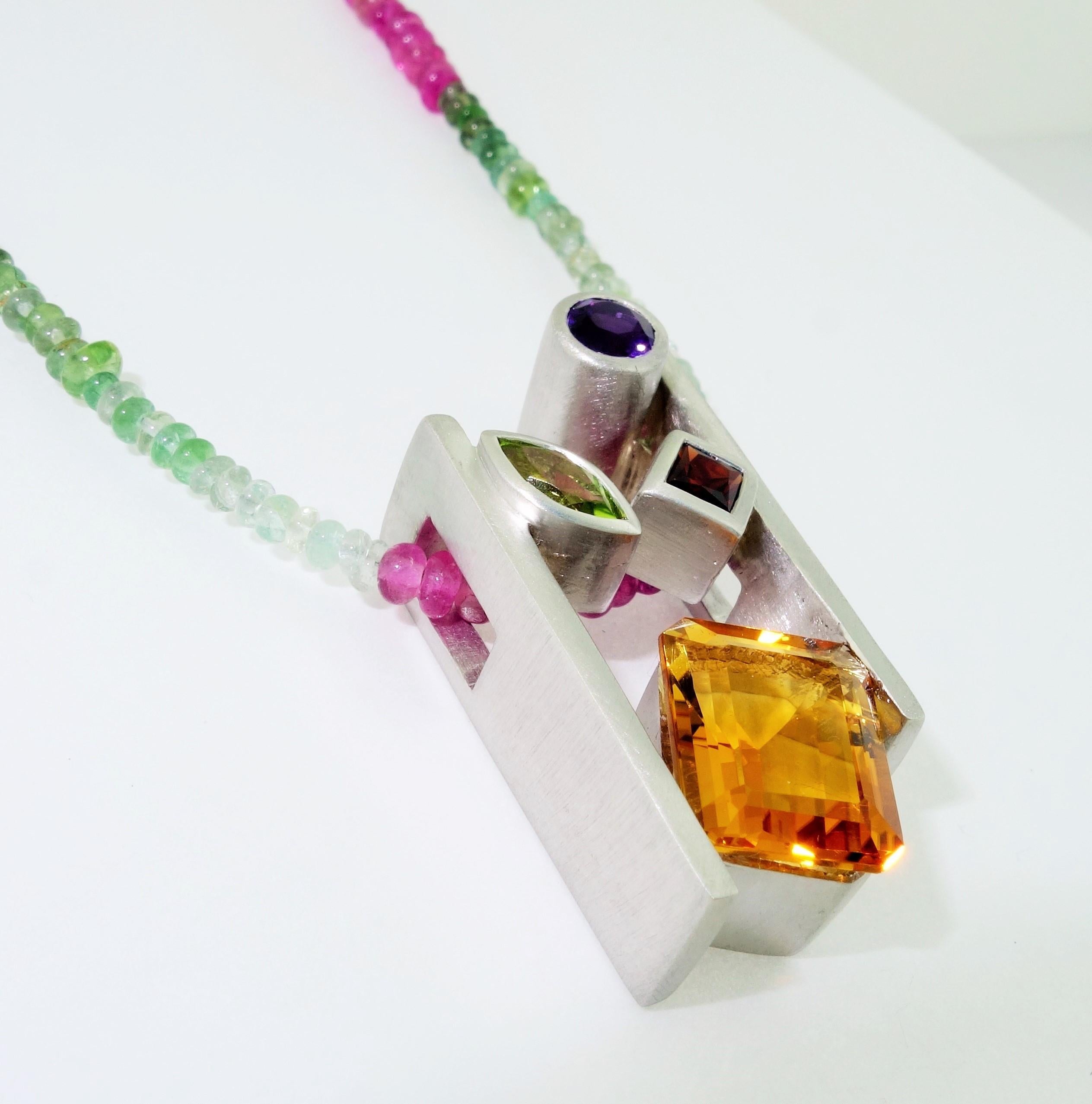 Beautiful and finely detailed Citrine, Amethyst, Peridot and Garnet Pendant set in Sterling Silver and suspended from a multi colored Tourmaline Necklace; approx. total weight of Gemstones: 4.91 Carat; The pendant is Hand crafted in Rhodium Sterling