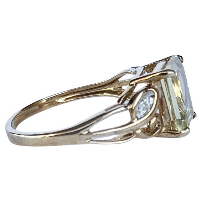 The gorgeous citrine stone is a soft yellow colour set in decorative claws with the detail carrying on to the shoulders. The shoulders hold a diamond point each. Modelled in 9carat gold. Hallmarked Birmingham 2007.

Ring Size: N or 6 3/4
Stone