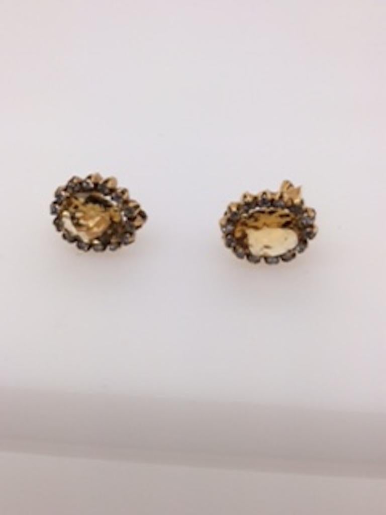 Sparkling faceted citrine and diamond ear clips.  The citrines are approximately 4.50 carats; the diamonds are approximately 1.10 carats.  Set in 18K yellow gold.  Secure clip=on closure.  3/4