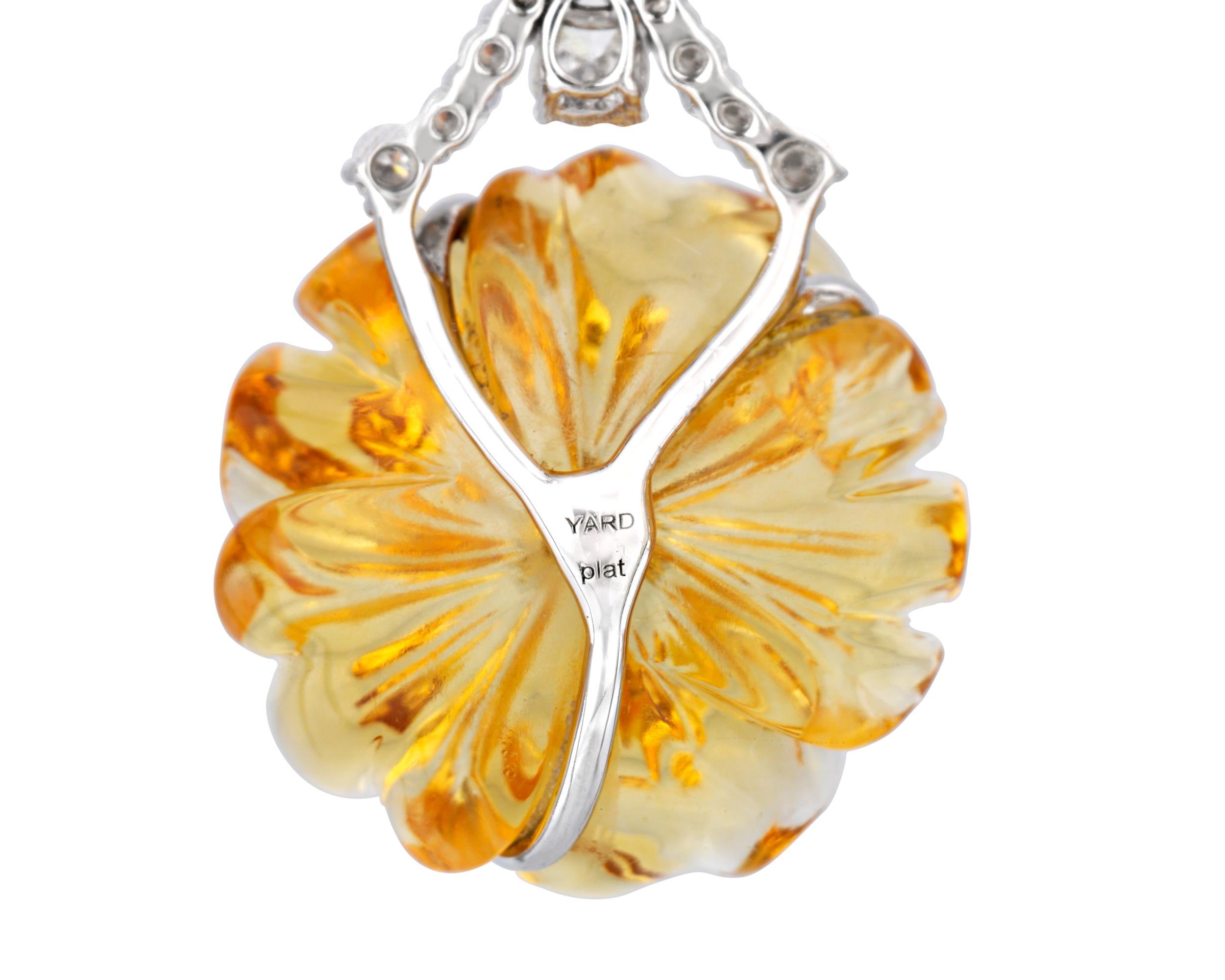 Citrine flowers bloom in these stunning carved gemstone earrings by Raymond Yard. The citrines, weighing a total of 17.90 carats, display a vivid shade of orange, while an array of marquise, pear and round white diamonds totaling 1.69 combined