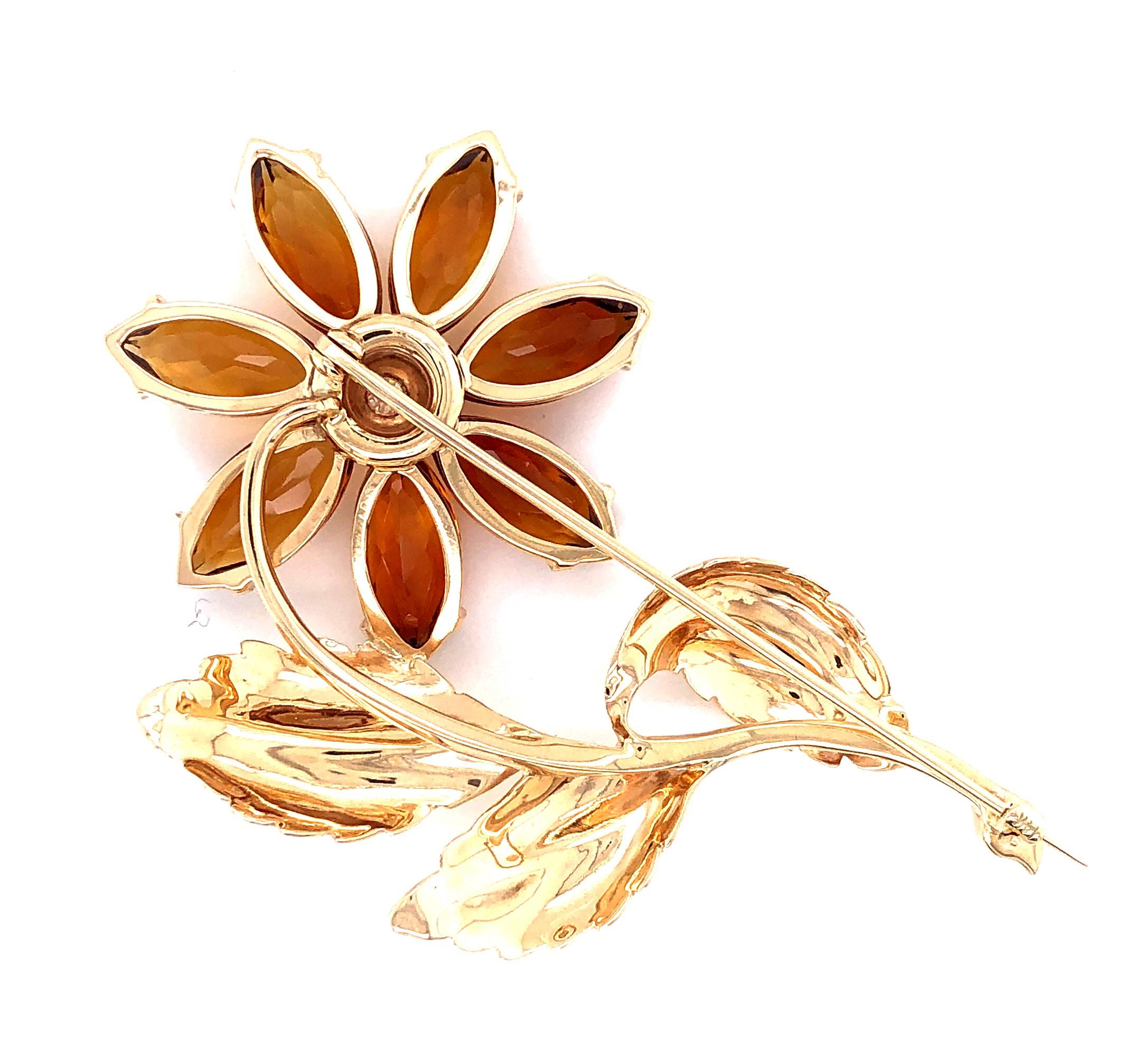 One 14 karat yellow gold brooch set with seven 14.5 x 7mm marquise shaped citrines and one bezel set round brilliant diamond, approximately 0.07 carat with H/I color and SI1/SI2 clarity.  