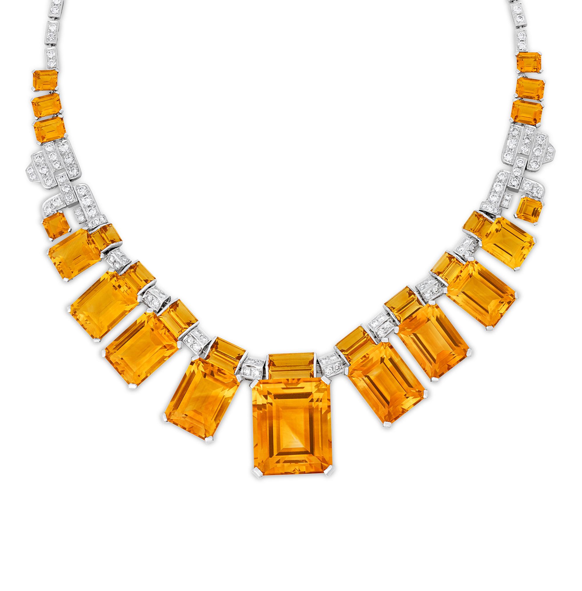 This monumental citrine and diamond necklace creates a striking visual effect across the neck. The citrine gemstones, totaling over 150.00 carats, offer a vibrant sunny hue, and are interspersed with glittering white diamonds totaling approximately