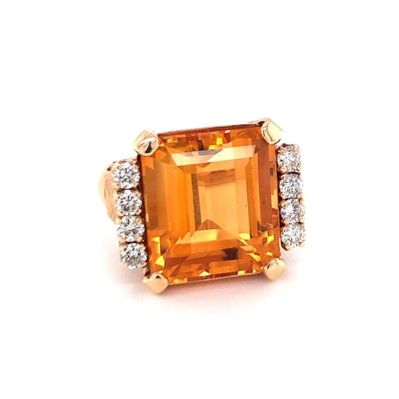 This exceptional 1960s ring showcases a sleek, high-polish 18K yellow gold setting that perfectly frames an 18-carat, emerald-cut citrine with vibrant orangey hues. The citrine is surrounded by eight round brilliant cut diamonds totaling 0.80