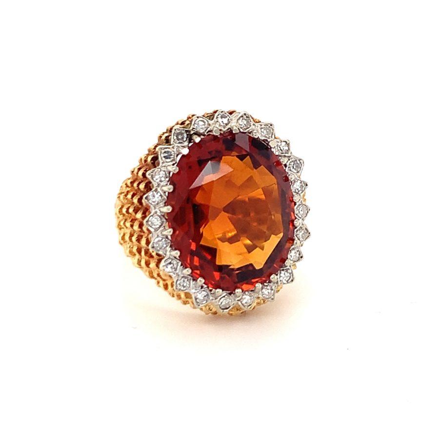 Deep fiery orange citrine and diamond ring in textured 18K yellow gold featuring a claw prong set, oval brilliant cut citrine weighing 8 ct. and 23 single round cut diamonds totaling 0.25 ct. with G color and VS-1 clarity.

Dashing, vibrant,