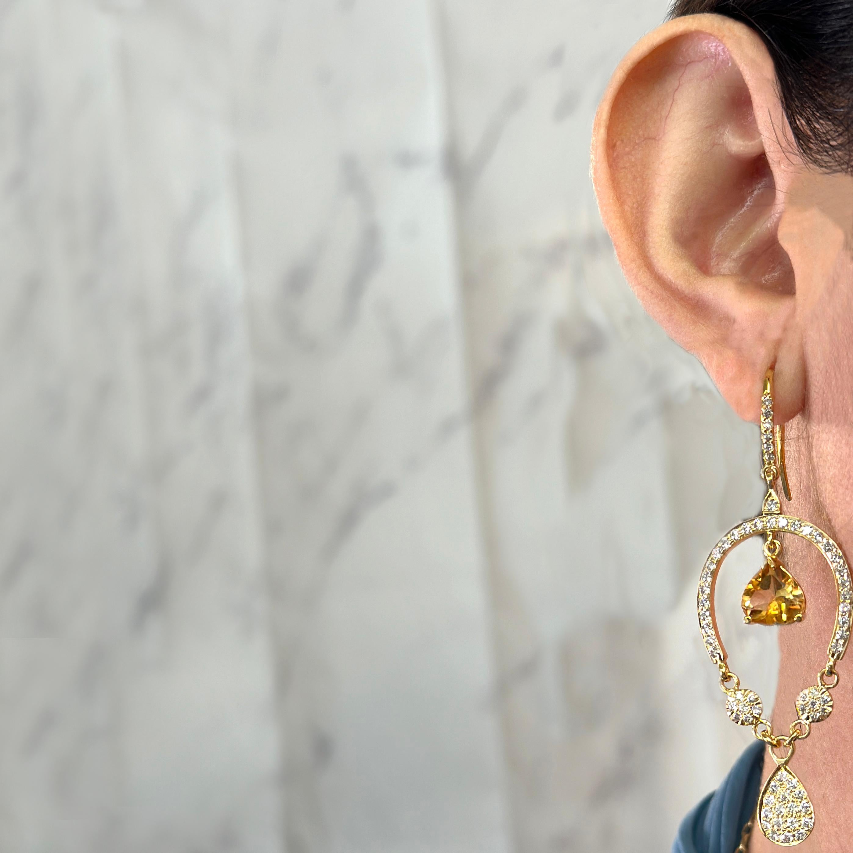 18 Karat Yellow Gold Drop Dangle Earrings Featuring 2 Heart Shaped Citrines Accented by 128 Round Diamonds of VS Clarity and H Color Totaling Approximately 2.00 Carats. 2.5 Inches Long with Shepherd's Hook. Finished Weight is 10.7 Grams.