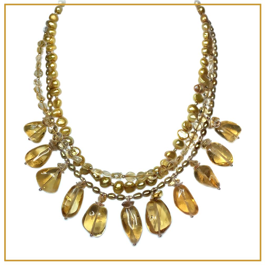 This is a citrine and pearl triple strand necklace. Nouveau Boutique  created this with citrine coin beads and dyed cultured pearls. It is hi-lighted with up to 20 mm translucent nuggets dangling from  the necklace. This Princess length rich golden