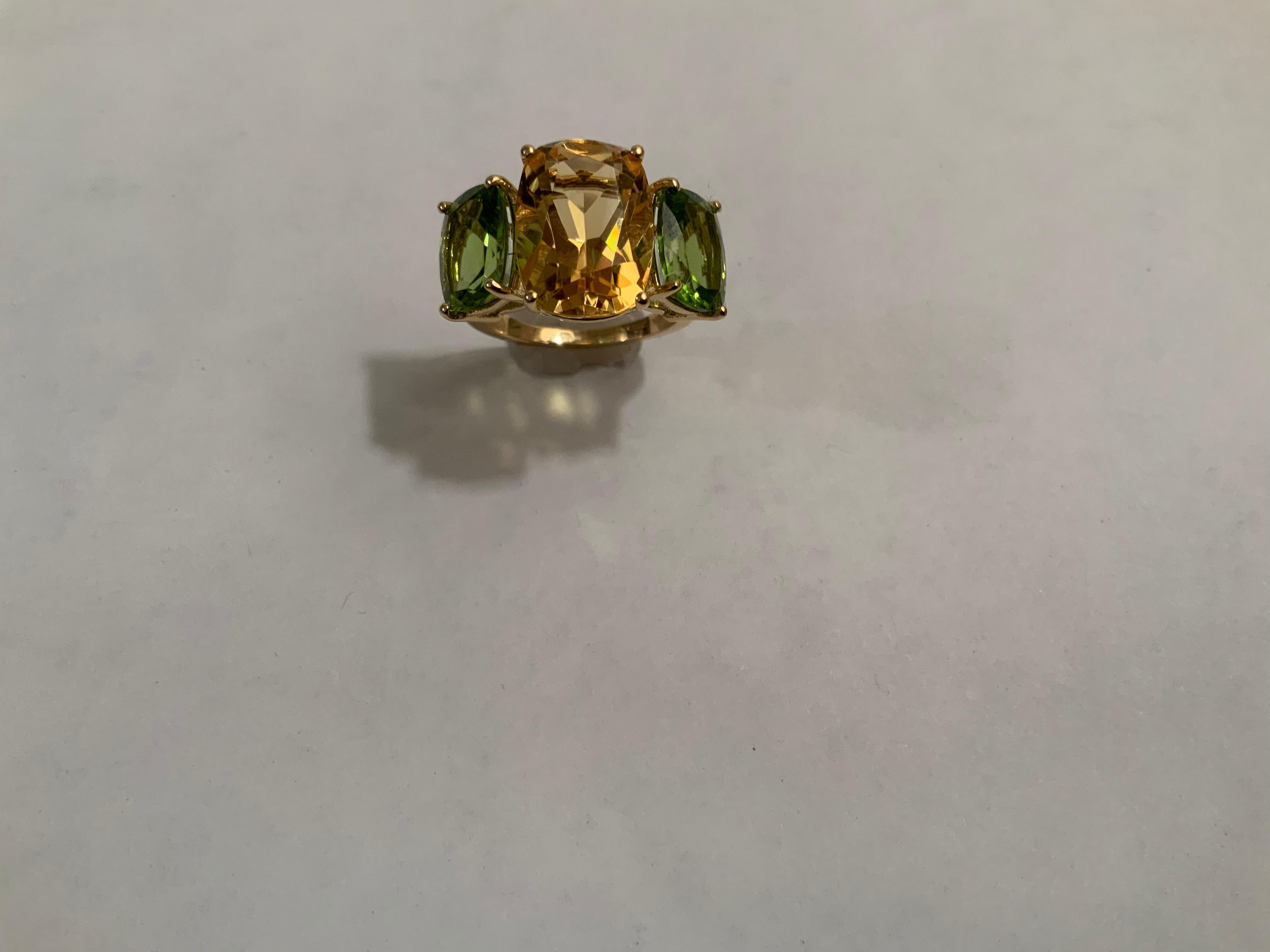 18kt Yellow Gold Three Stone faceted Cushion Cut Ring with center Citrine and Peridot finished with a tapered split shank.

This elegant cocktail ring measures 1 1/4