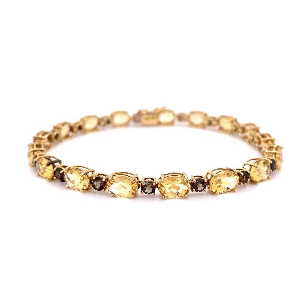 Simply Beautiful! Citrine and Smokey Quartz Gold Vintage Line Bracelet. Hand set with 10tcw Citrine and 2.00tcw Smokey Quartz. Hand crafted in 14K Yellow Gold. Measuring approx. 7” long. Chic and Classic and so easy to wear...A sure to be admired