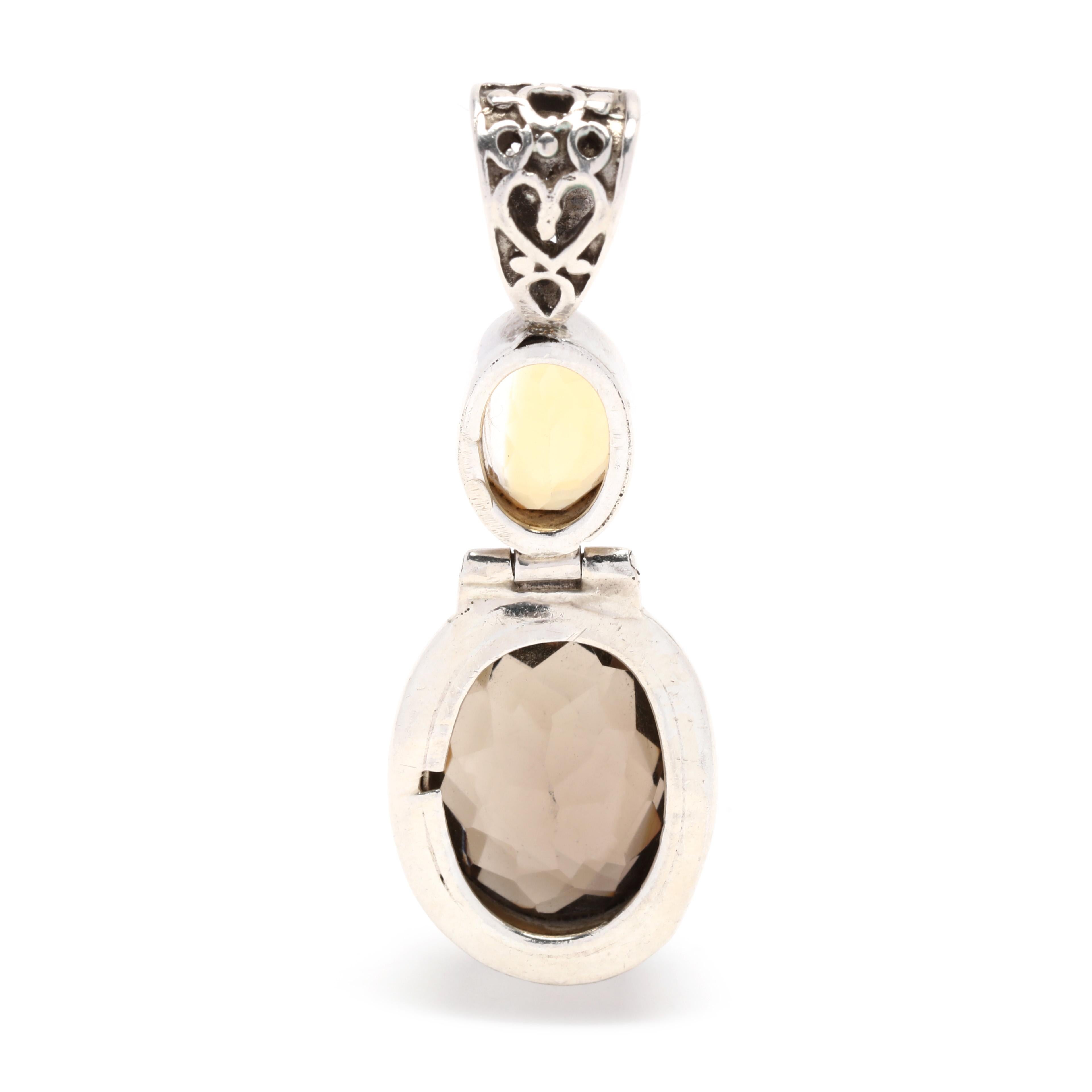 This stunning pendant features a unique combination of a citrine and smoky quartz gemstones set within sterling silver. The elegant design of the pendant measures 2.25 inches and is the perfect way to add a touch of sparkle and sophistication to any
