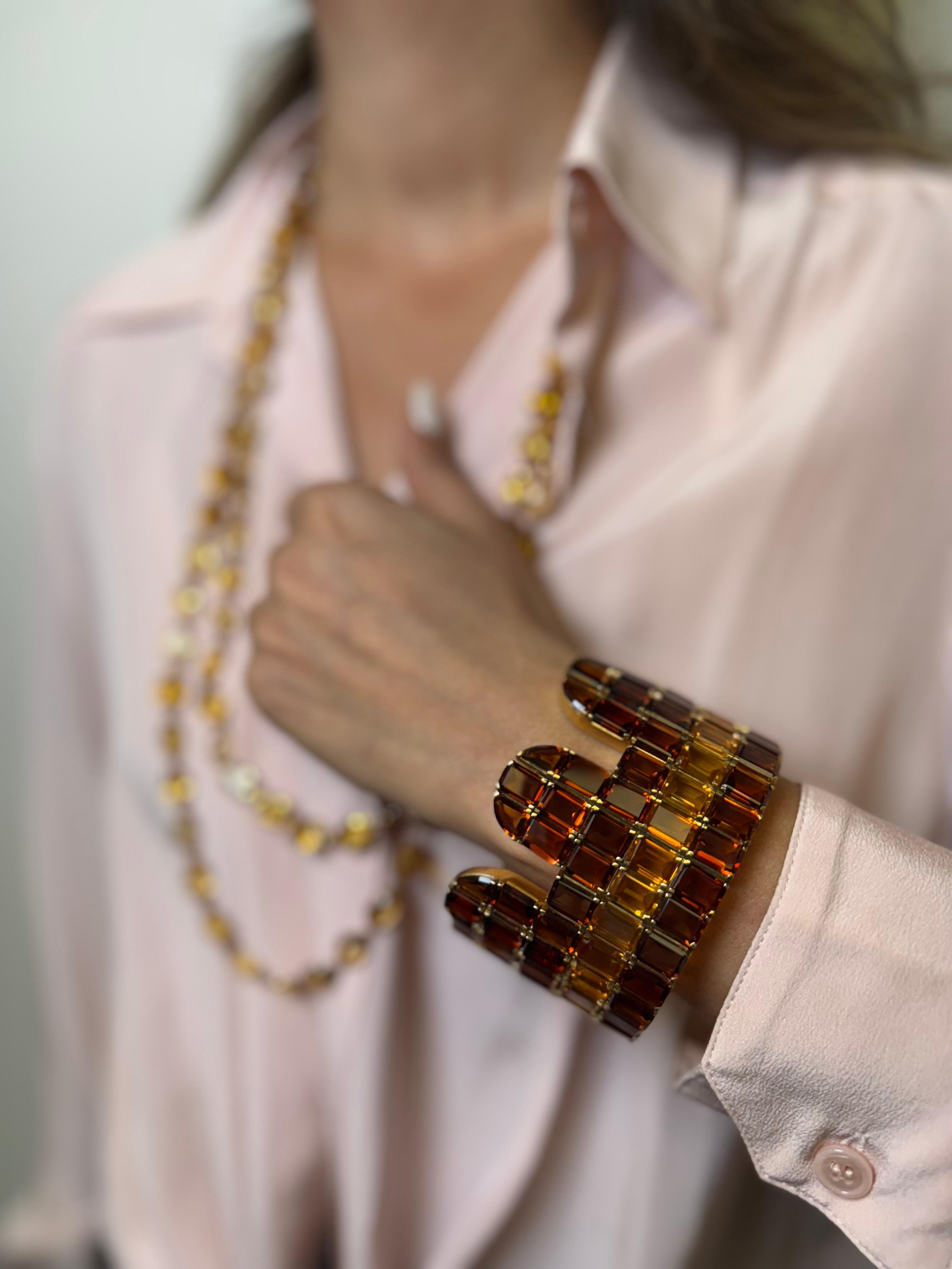 18K yellow gold citrine and topaz multi-row bracelet is a statement of elegance and sophistication. Featuring meticulously set emerald-cut citrine and topaz gemstones