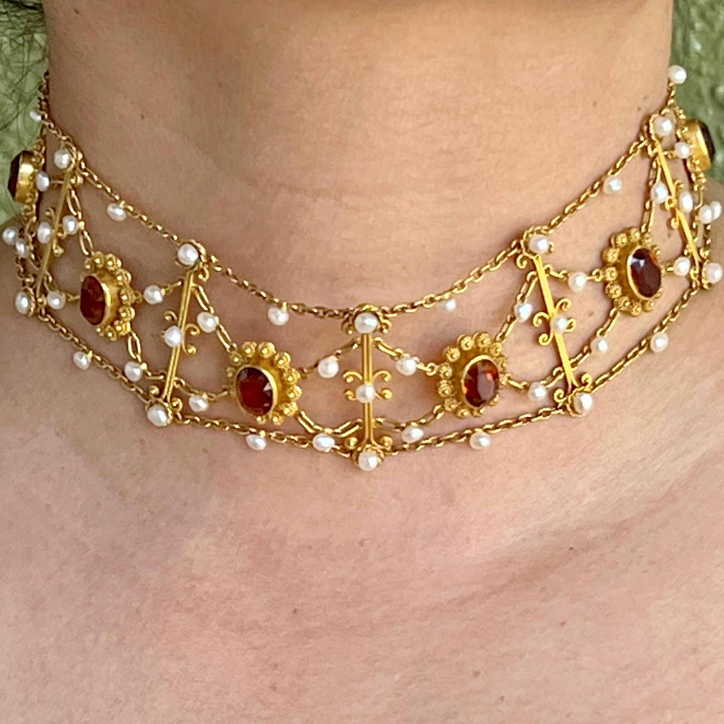 This choker is hand crafted in 18 Karat gold with deep amber faceted oval citrines suspended from a chain matrix with tiny white seed pearls that accent the granulation throughout. Each section is perfectly matched to lay beautifully on the neck as