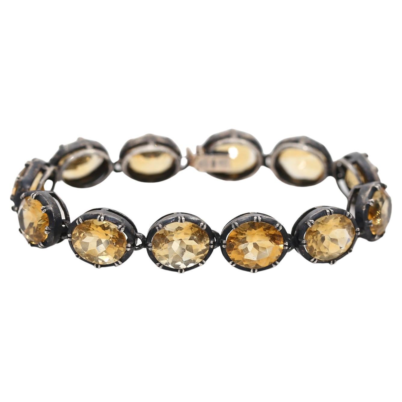 A Citrine Bracelet in 9 Karat  Yellow Gold and Silver, set with a row of oval cut citrines in pinched collet settings, stamped 375. Created at the beginning of the 20th century.

A true future classic, its value will be sure to rise as time goes by.