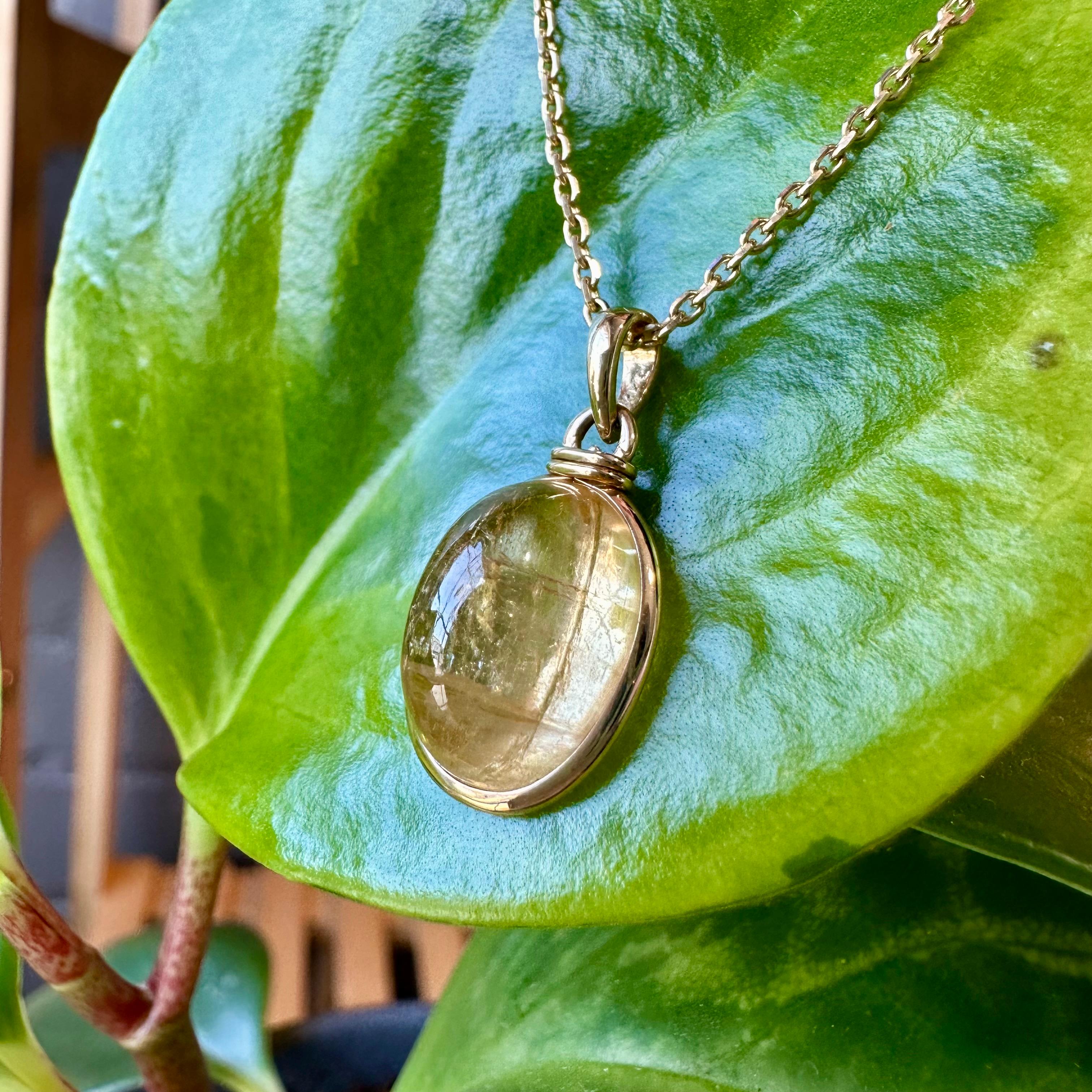 Wear a delicious, crystalized drop of sun-soaked honey with this citrine and 14k gold pendant necklace. The natural inclusions in the citrine cabochon let the stone glow in any light, and the yellow gold bezel setting enhances its sunny warmth.