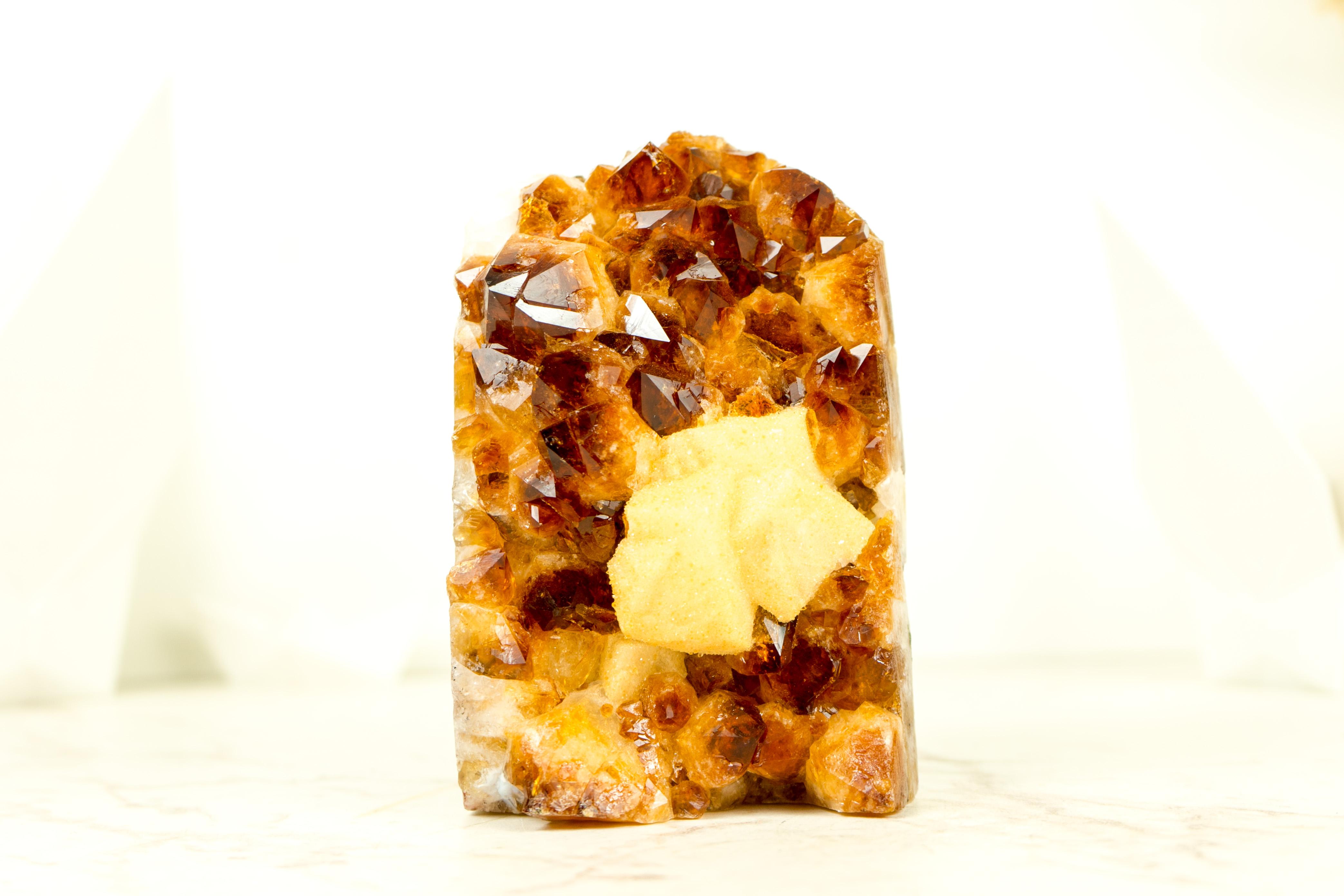 An Amber Citrine Cluster that brings world-class citrine color, rare geometrical calcite covered by Sugar Druzy, and gorgeous aesthetics. This small yet gorgeous crystal promises to be a stunning addition to your office table, home decor, or crystal