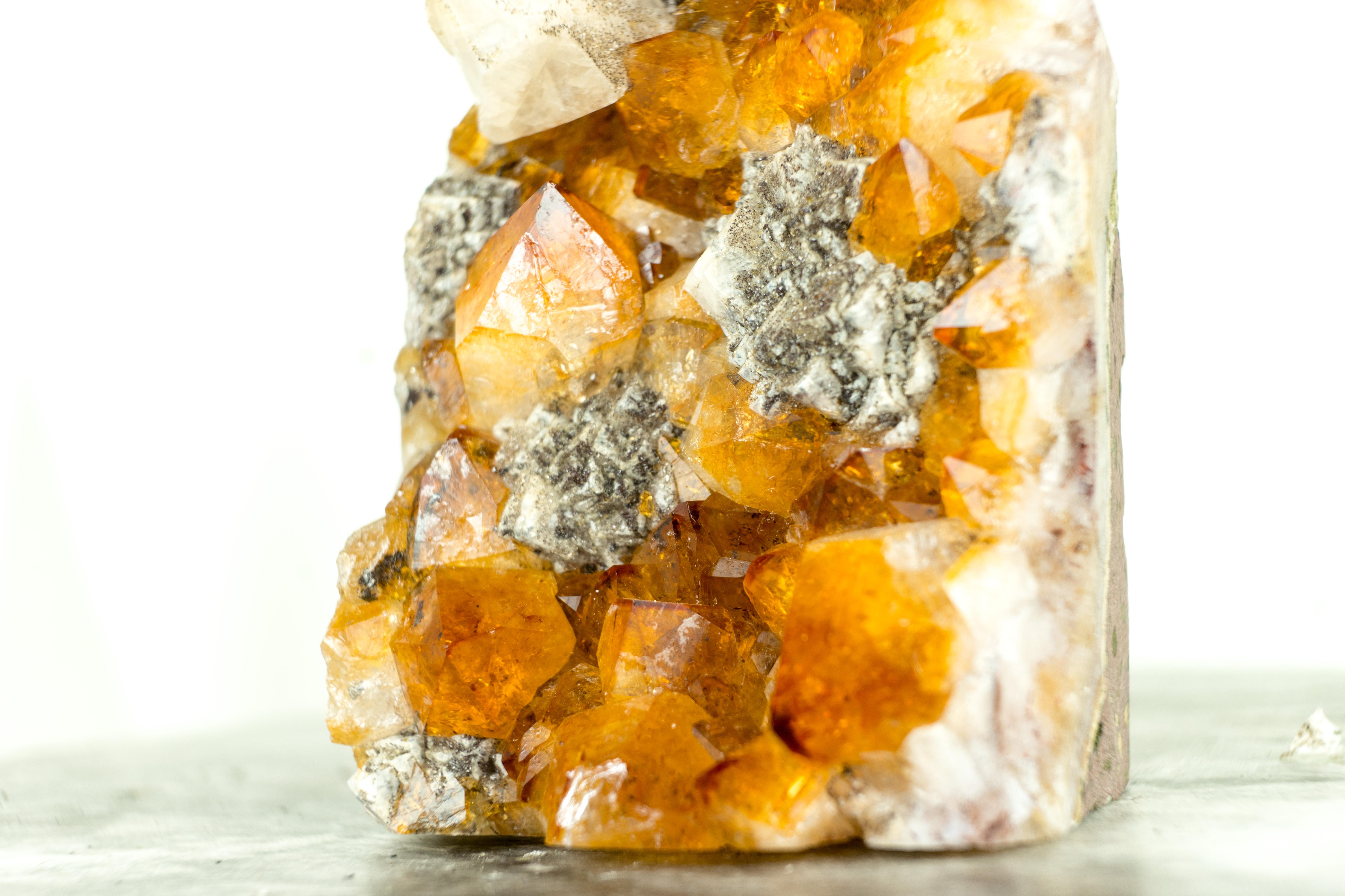 A Rare Citrine Cluster that boasts world-class citrine color tones, rare geometrical calcite inclusions, and beautiful aesthetics. This small yet gorgeous crystal promises to be a stunning addition to your office table, home decor, or crystal