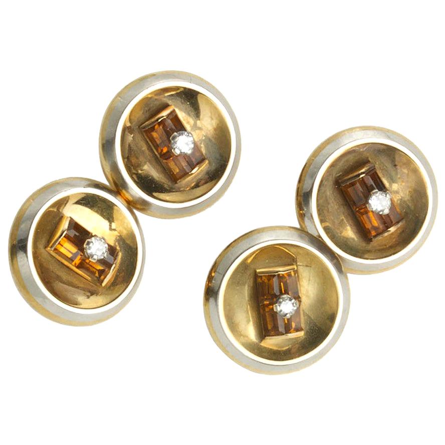 A pair of French, citrine, diamond, gold and platinum cufflinks, set with an eight-cut diamond in the centre of four baguette-cut citrines, onto a concave gold disc, with a platinum edge, mounted in 18ct yellow gold, with French eagle head marks,