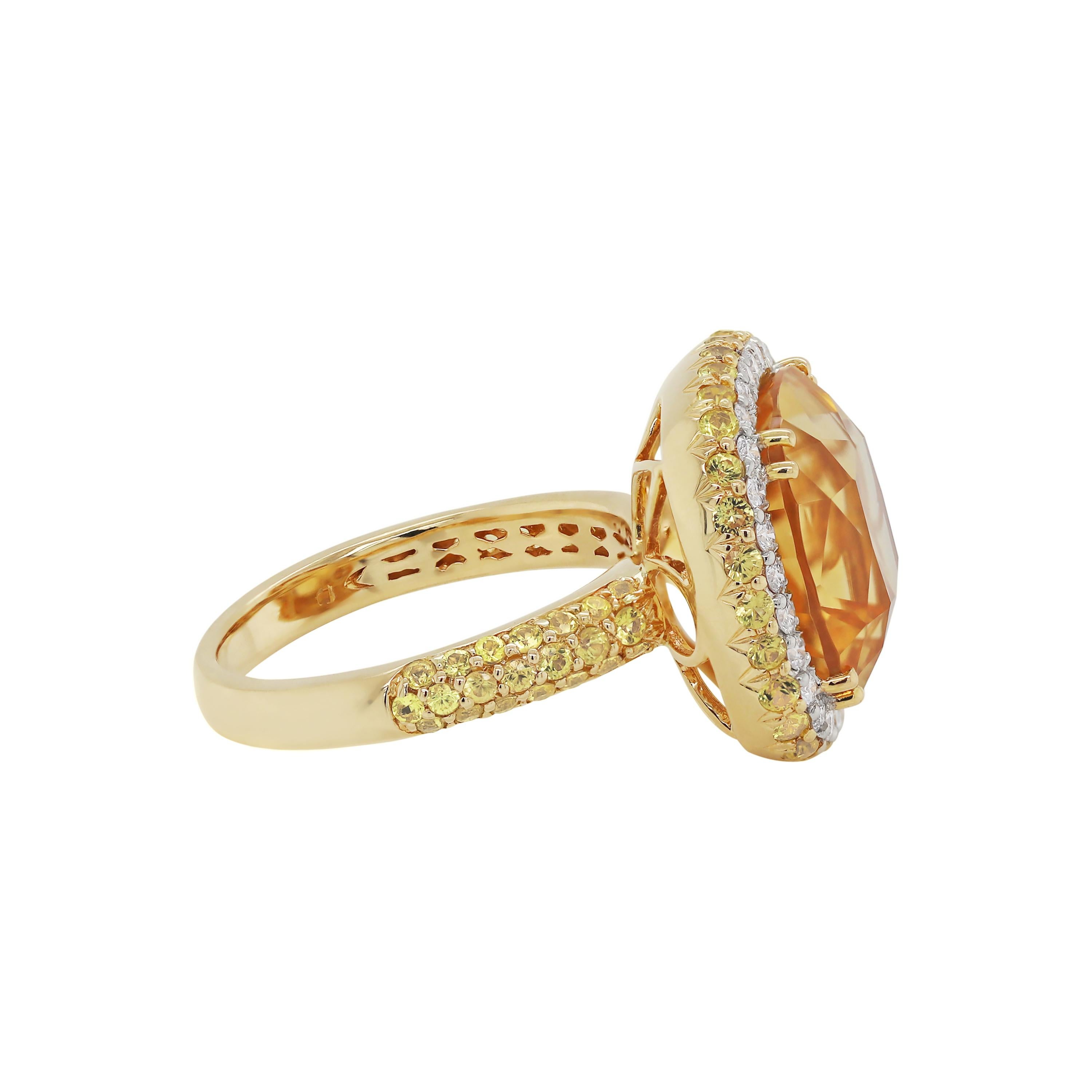 This modern ring features a golden coloured cushion cut citrine measuring 13x13mm and 9mm in depth, claw set in the centre. The beautiful stone is surrounded by a halo of 28 fine quality round brilliant cut diamonds weighing an approximate total