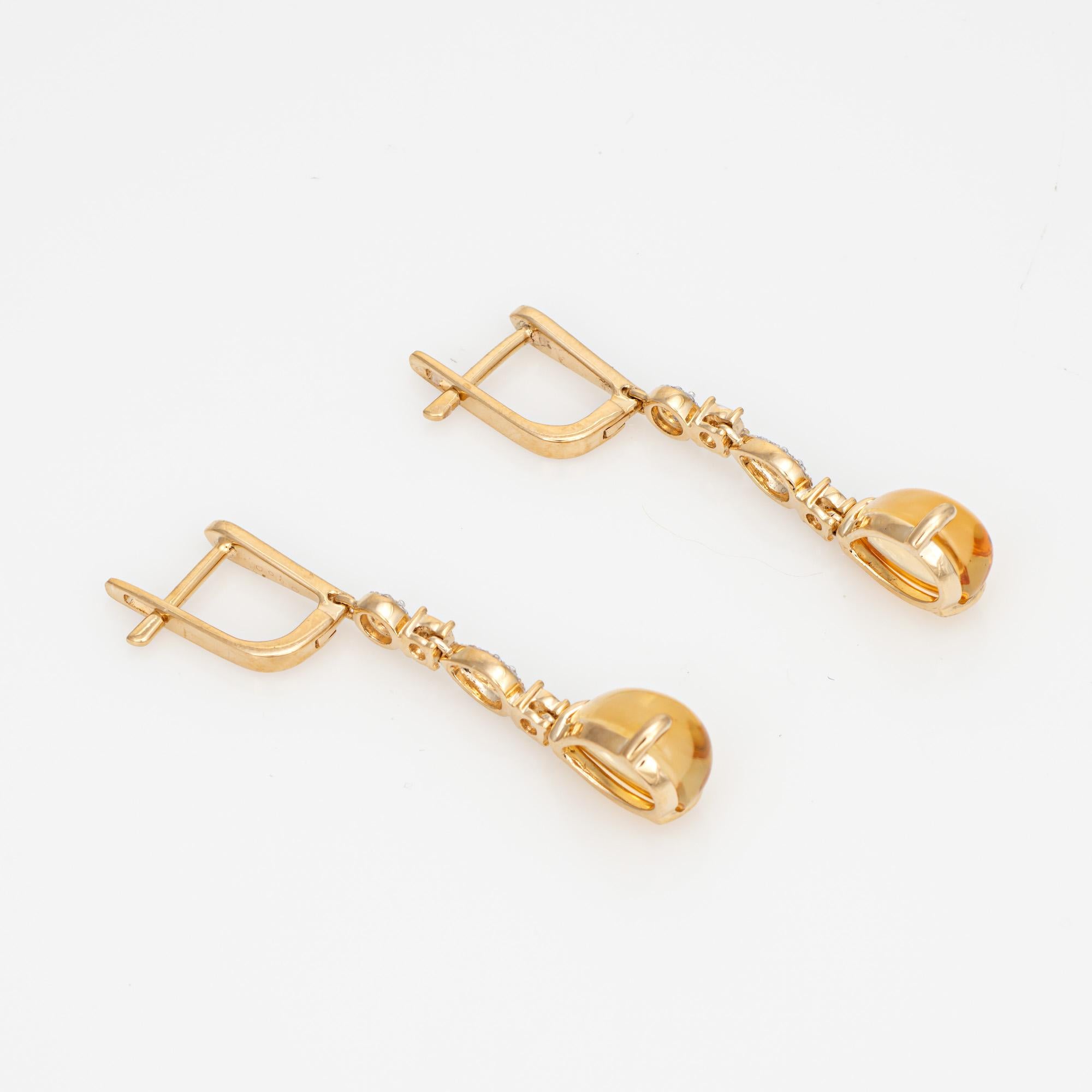 Elegant pair of citrine & diamond drop earrings, crafted in 14k yellow gold. 

Pear cut citrine cabochons are estimated at 2 carats each, accented with an estimated 0.10 carats of diamonds (estimated at H-I color and VS2-SI2 clarity). The citrines