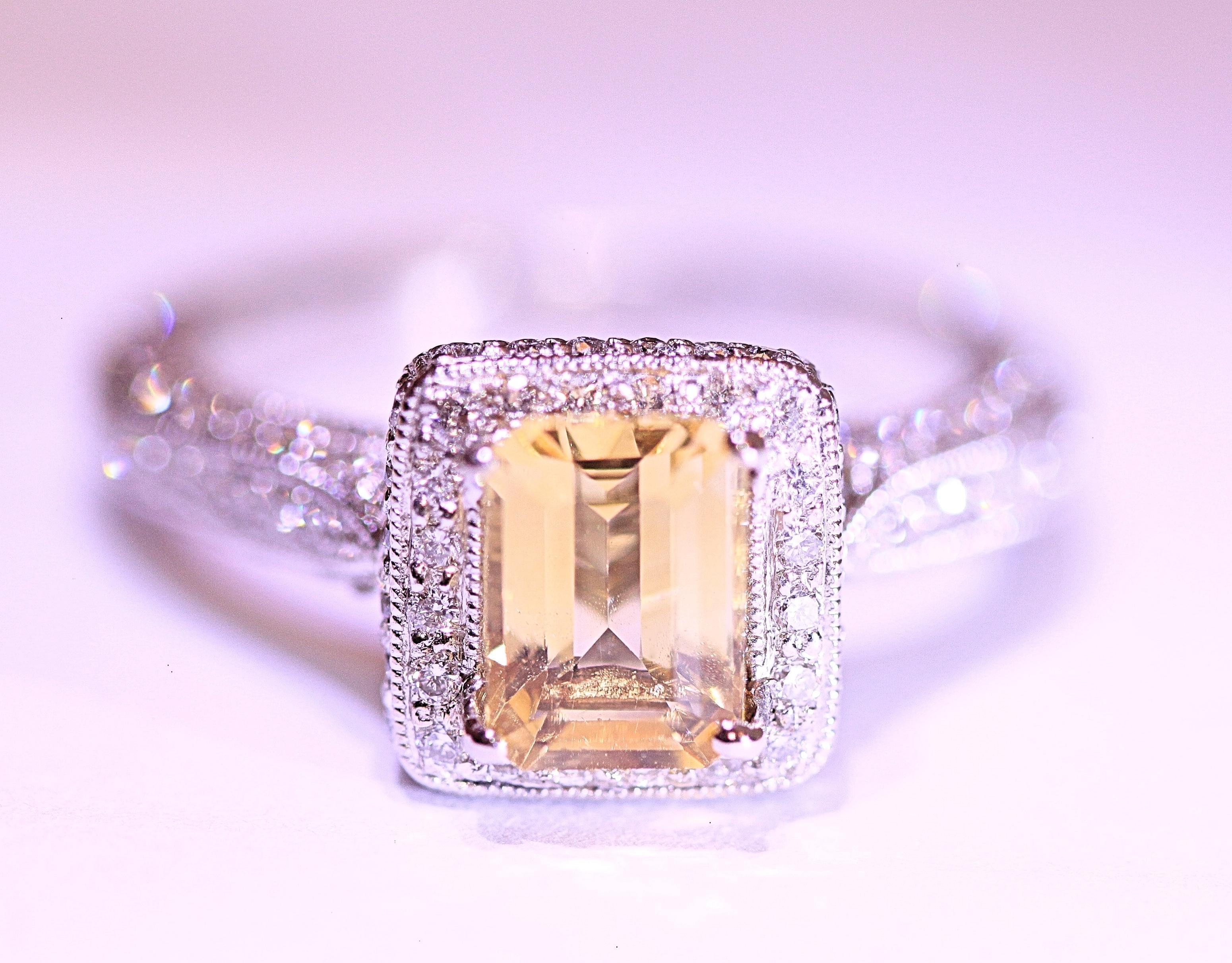 A beautiful, affordable citrine ring that can be used as an engagement ring or right hand ring.
The ring has one emerald cut citrine that weighs .84 carat total.  The citrine is surrounded by
pave' set round brilliant cut diamonds.  The diamonds
