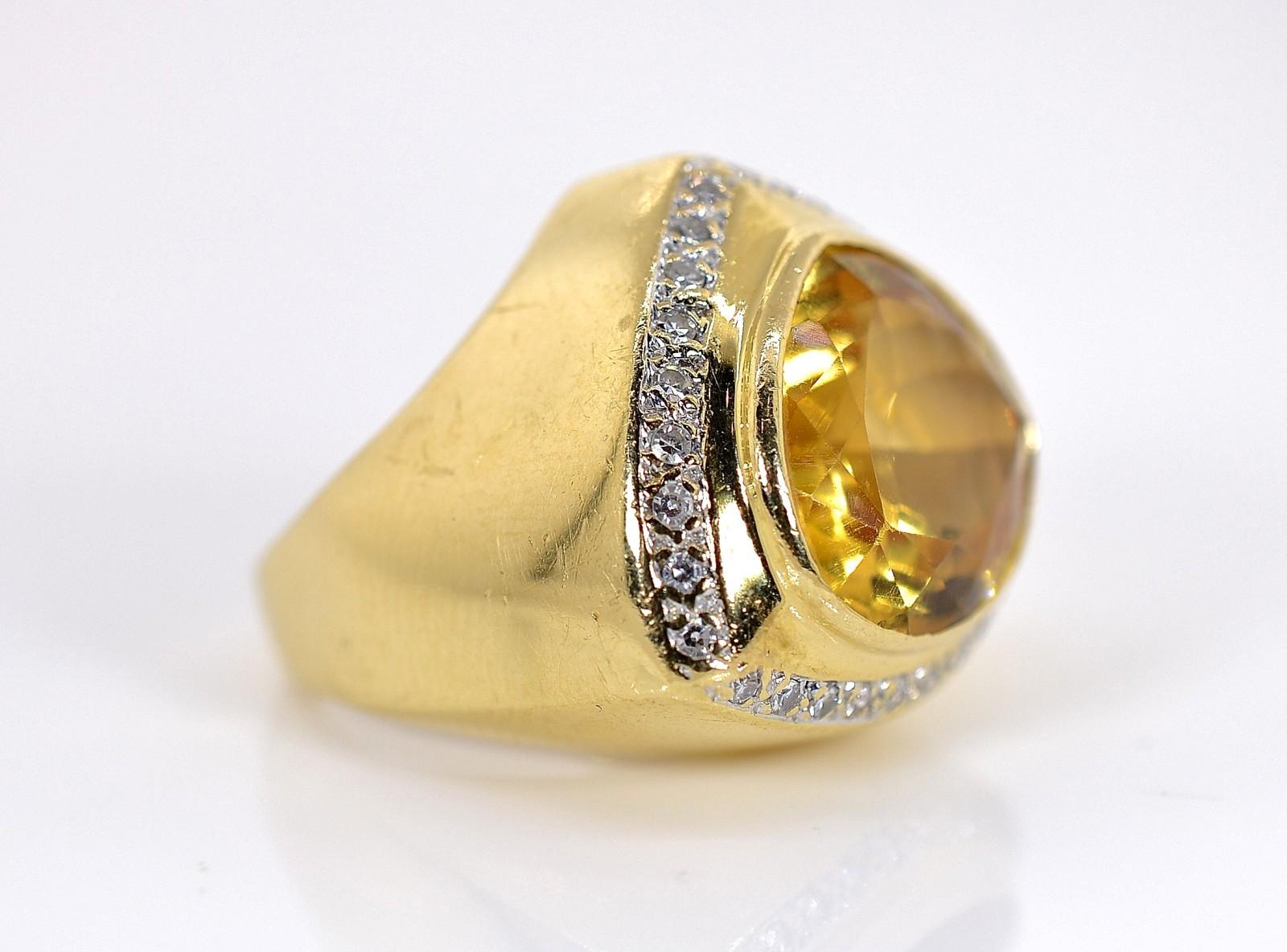 A bezel set approx. 14.00 carat yellow Citrine Quartz is the centerpiece of this distinctive ring.  The Citrine is surrounded by small sparkly Round Diamonds, all weighing approx. 0.45 carat of H/I color - VS clarity.   The bow triangle design of
