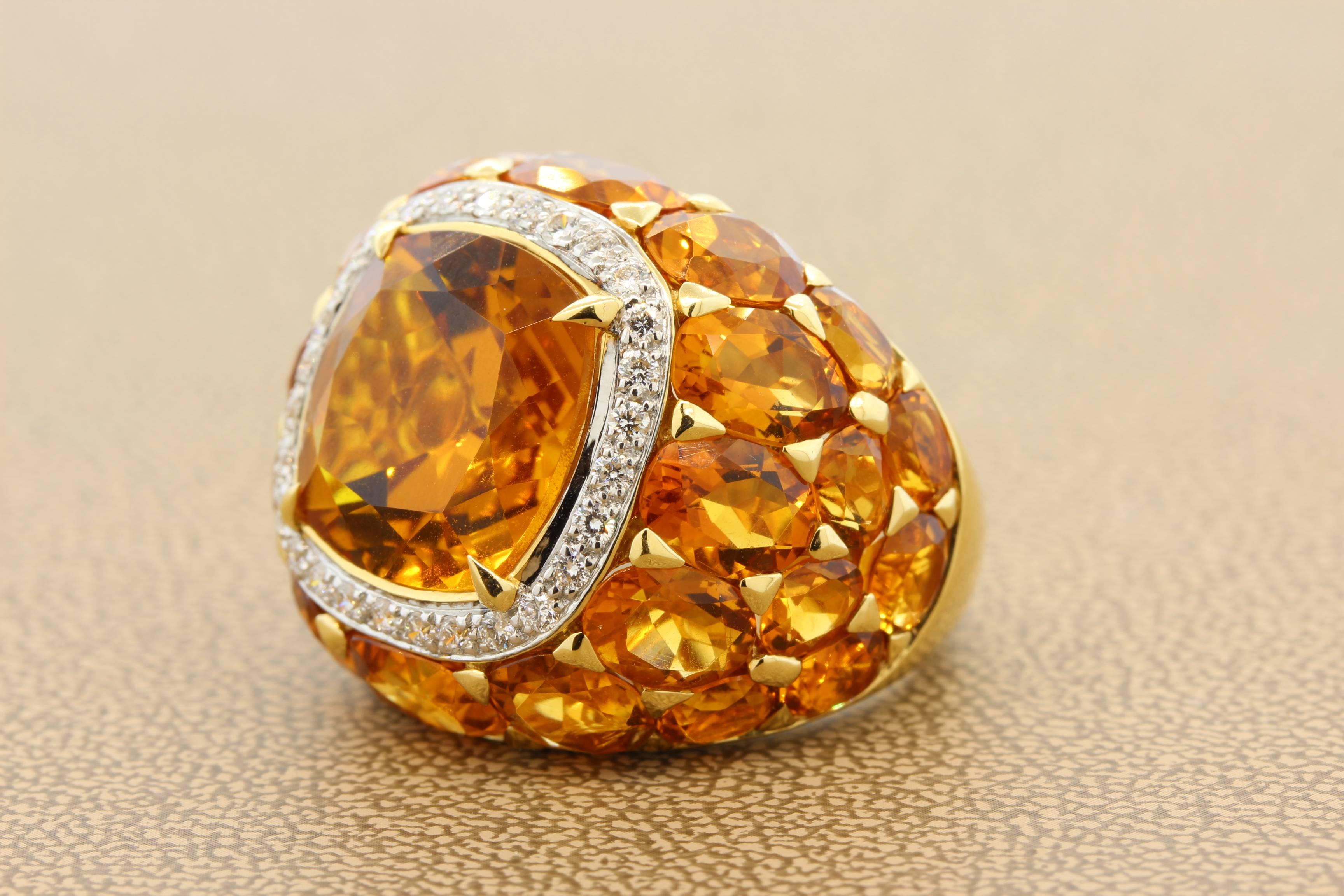 A bold look, this cocktail ring features a 11.28 carat cushion cut citrine which is haloed by 0.52 carats of diamonds. Around the ring are 17.30 carats of oval shape citrine giving it it’s unique look. 

Set in 18K yellow gold, a special ring for a