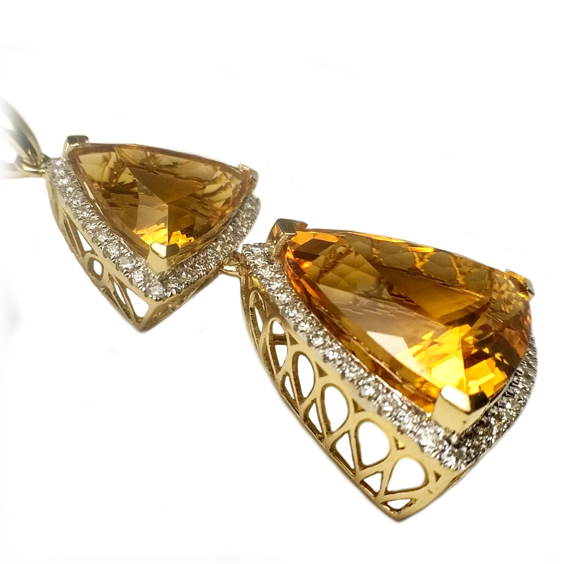 Dangling citrine diamond pendant. Handcrafted high luster, golden honey yellow 28.90 carat trillion faceted two citrines, encased in basket mounting with total six split prongs. Accented with round brilliant cut diamonds. Contemporary design set in