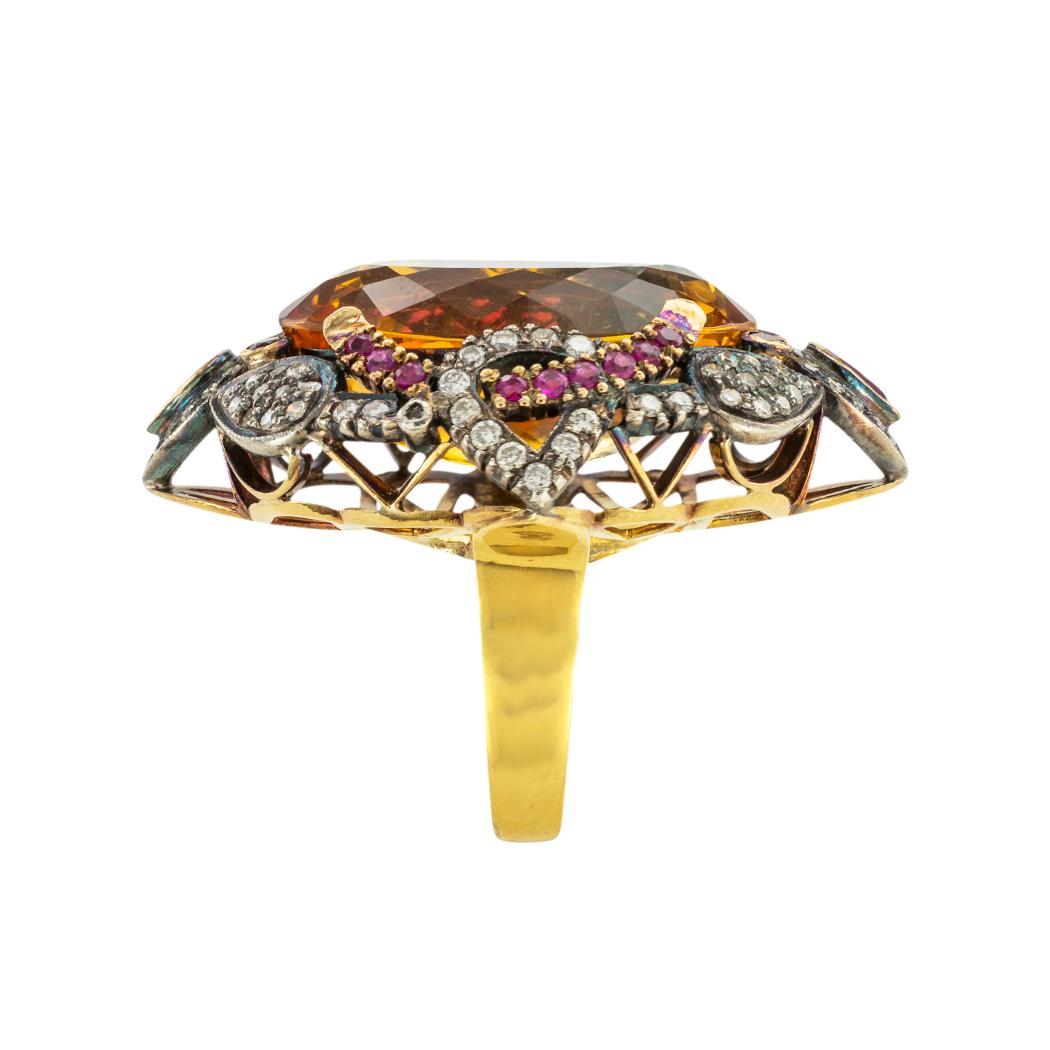Large Citrine diamond and ruby silver and gold cocktail ring. *

ABOUT THIS ITEM:  #R-DJ69F. Scroll down for detailed specifications.  This ring showcases a very large and vibrant citrine at its center surrounded by diamonds and rich rubies arranged