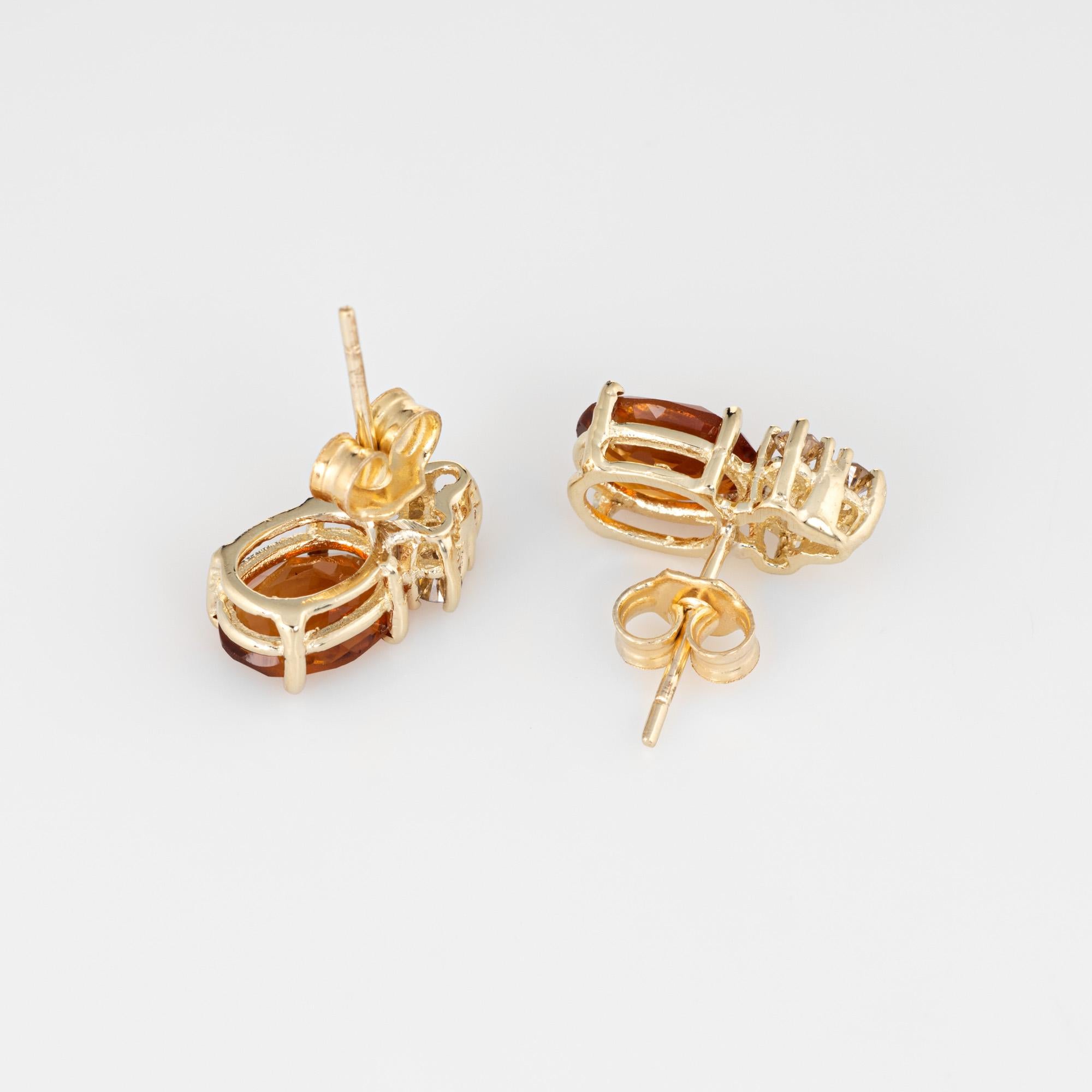 Elegant pair of vintage citrine & diamond small stud earrings crafted in 14k yellow gold. 

Oval faceted citrine are estimated at 1 carat each (2 carats total estimated weight). The diamonds total an estimated 0.18 carats (estimated at L-M color and