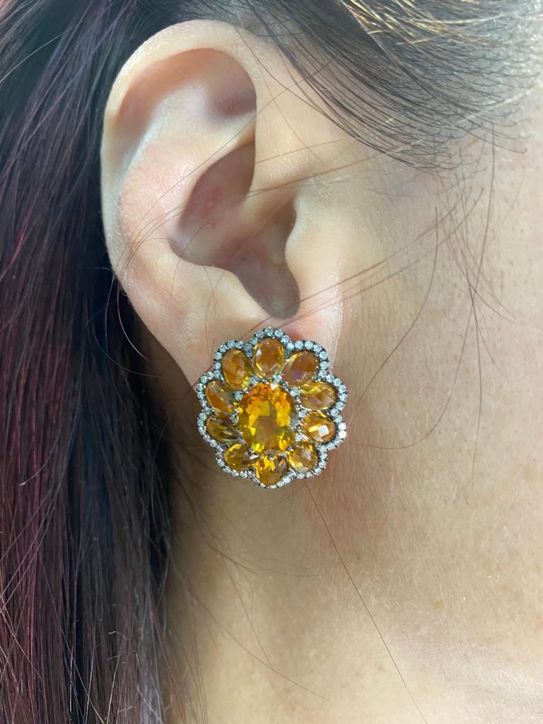 This earrings feature 2 citrine at the center weight 4.4 carats, the center stones are surrounded by 20 citrine weight 6.75 carats. The nuts diamonds on the outer edge weight 0.88 carats. Matching ring is available, please visit our storefront or