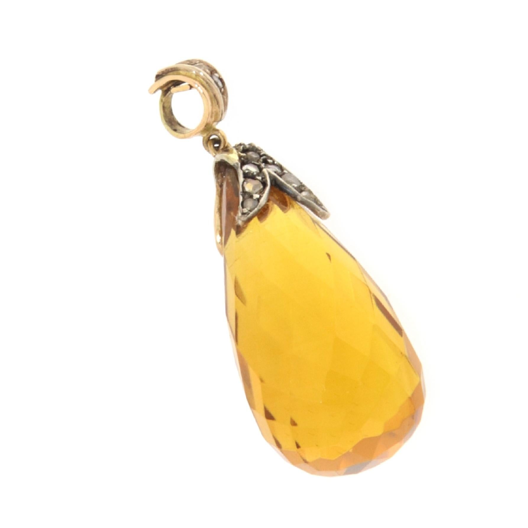 This exquisite pendant, an elegant blend of 14-karat gold and sterling silver, is a demonstration of sophistication and splendor. At its heart, a briolette drop of citrine, selected for its golden luminosity and crystal clarity, hangs gracefully,