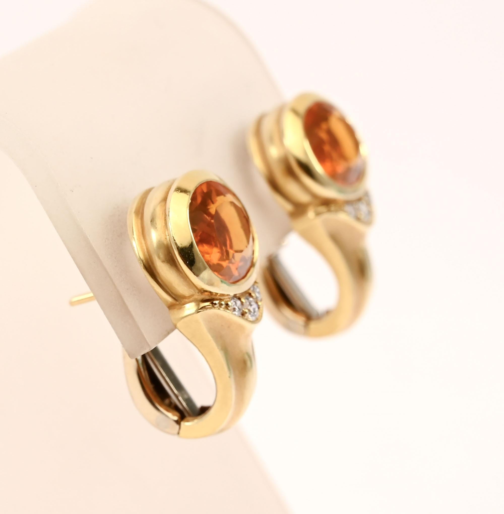 Fashionable citrine earrings highlighted by three diamonds on each. The faceted citrine measures 1  cm wide and half a centimeter long. Below the citrine are 3 diamonds that weigh .15 carats total. Backs are posts and clips that can be modified to